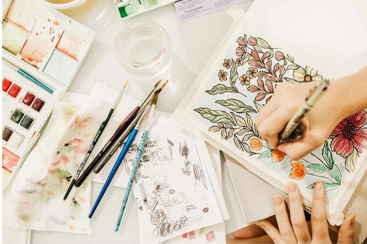 Parent receiving parent coaching while kneeling in a kitchen handing a boy with a backpack a lunchbox