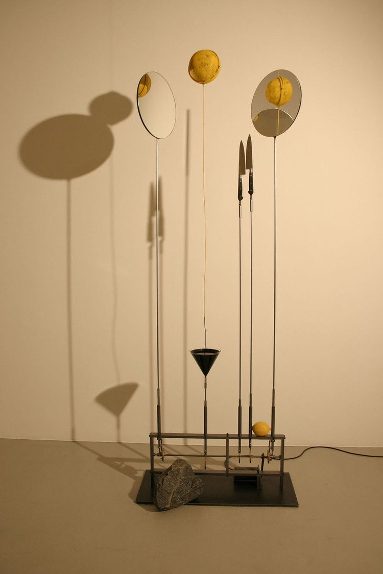 3. Rebecca Horn, Luna Limone, 2004, electronic device, yellow metal sphere, knives, mirrors, black ink, lemon, granite stone, 194 x 79 x 39 cm.jpg
