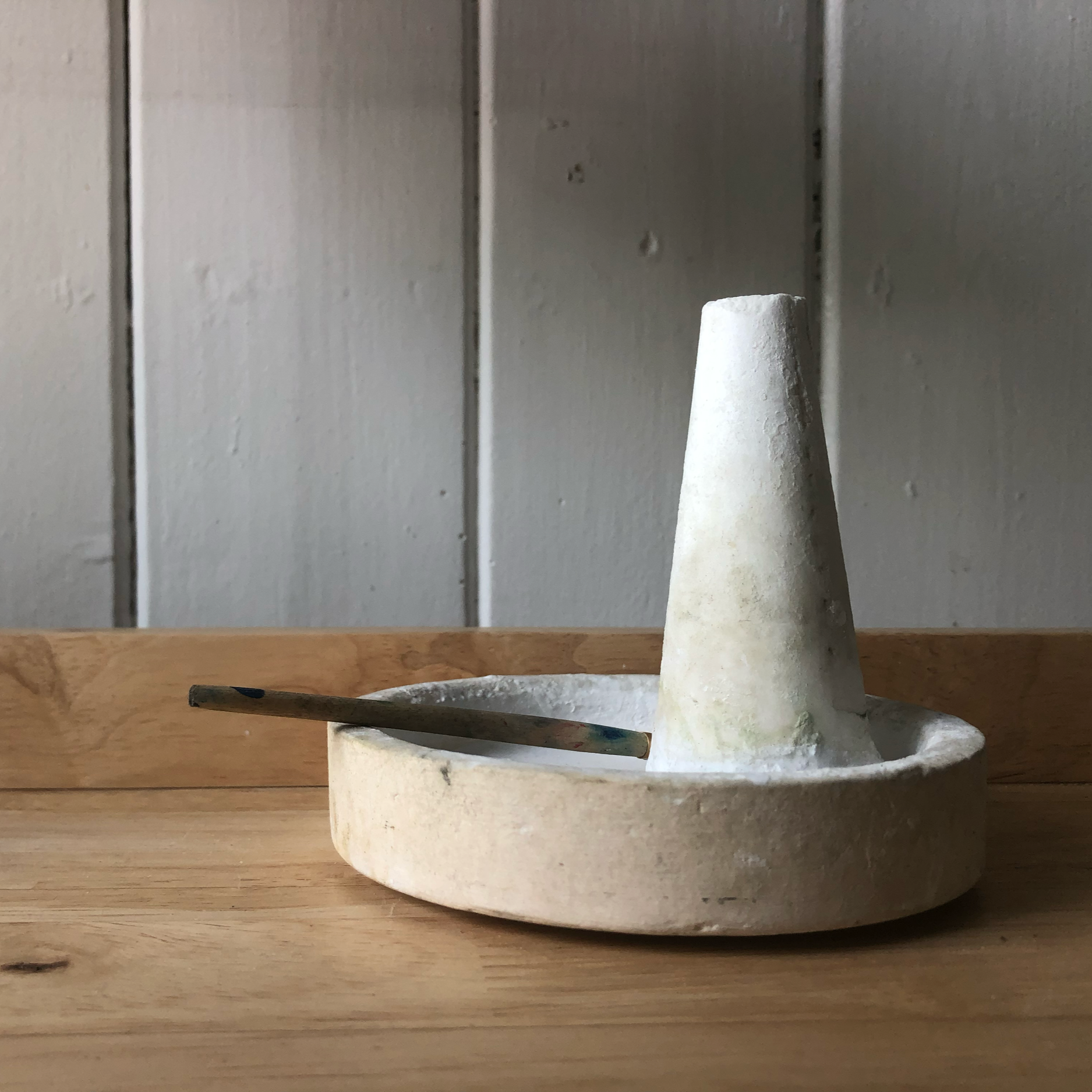 Borax cone with paint brush pictured on my workbench in the smallest stuio