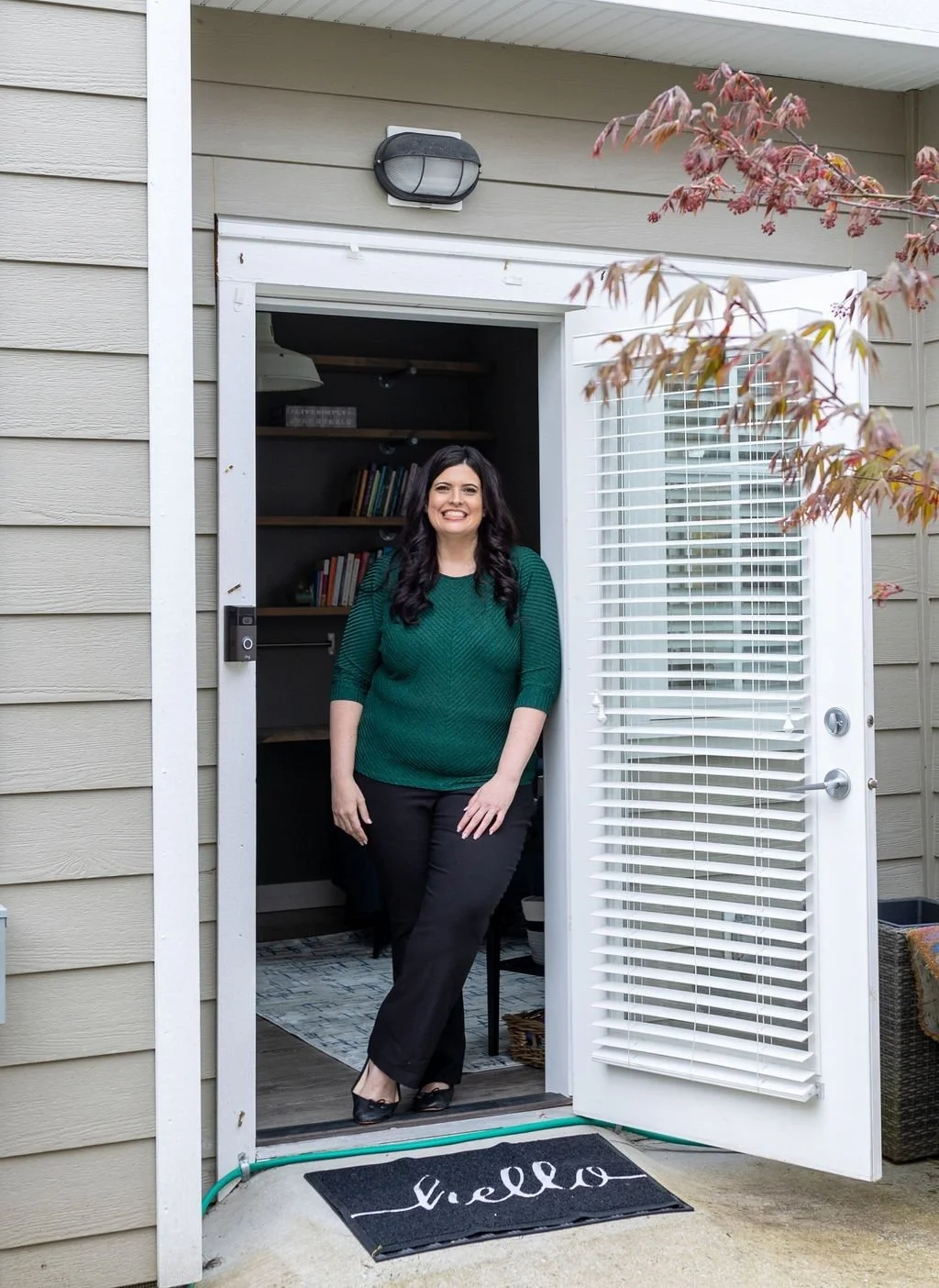 Elizabeth Nardella smiling in the doorway of her South Surrey office, ready to welcome you