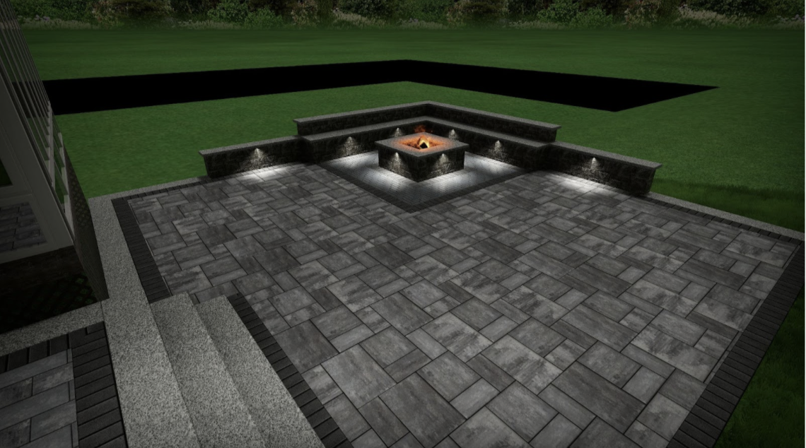 Night view of a backyard patio with a fire pit, gray stone tiles, and surrounding grass.