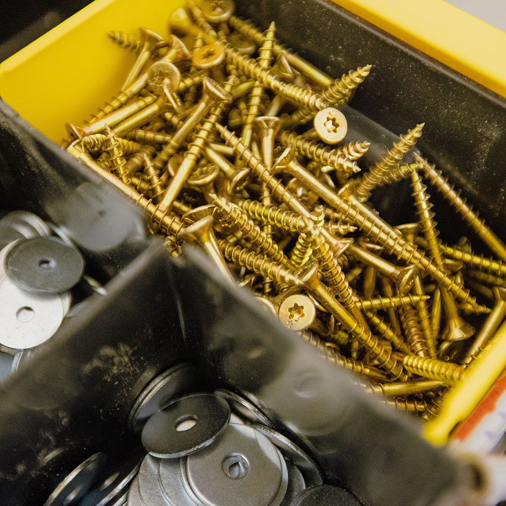 Box of screws and washers in a box with several compartments.