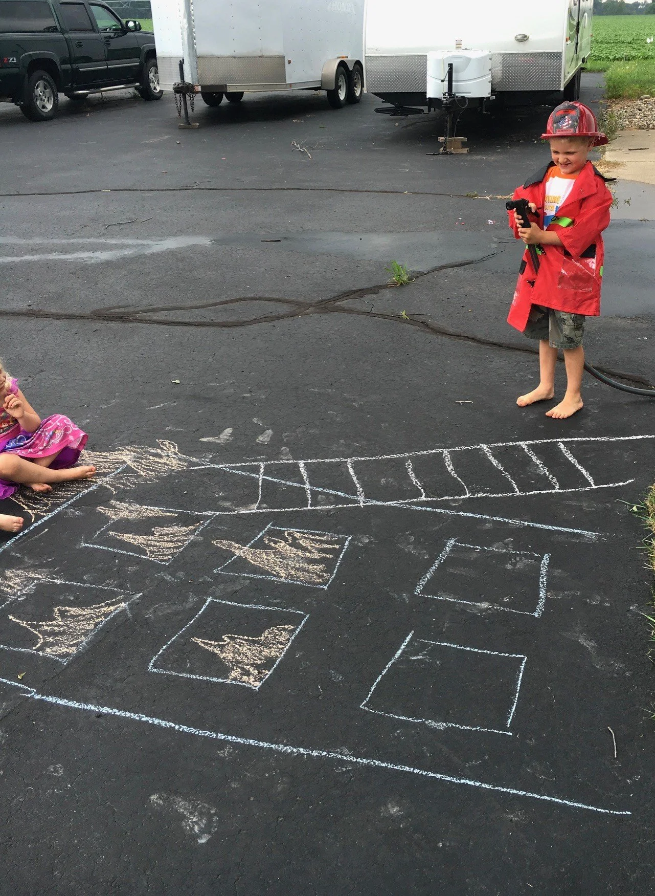 spraying with hose fire fighter chalk game.jpg
