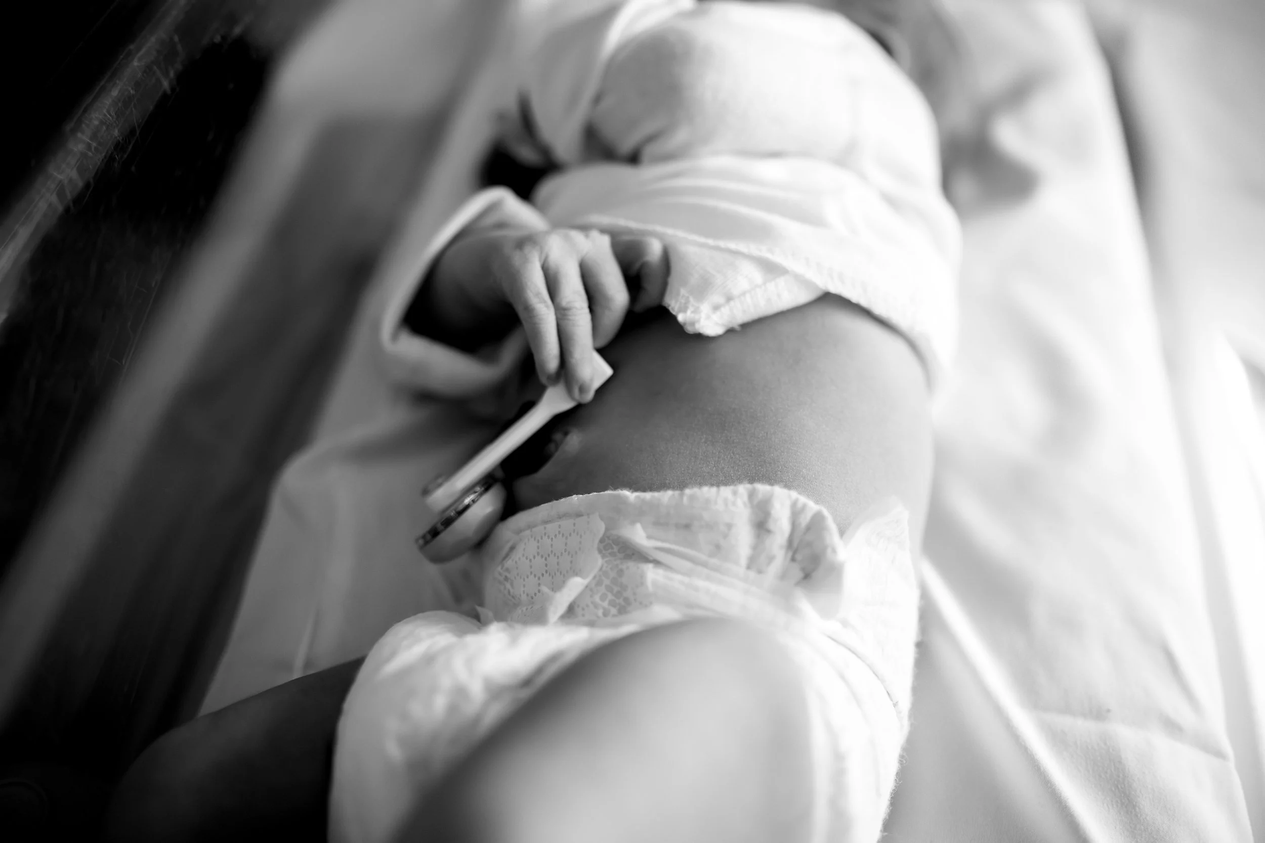 Close-up of a newborn baby, in black and white.