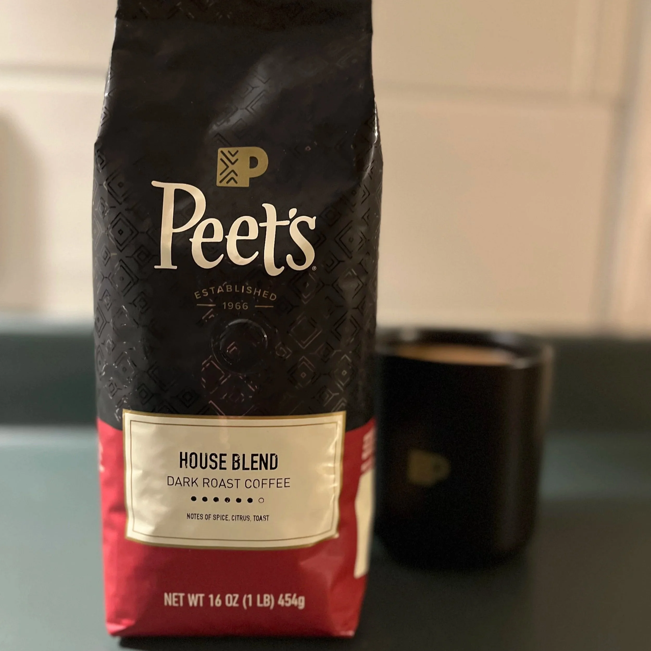 bag of coffee beans next to mug