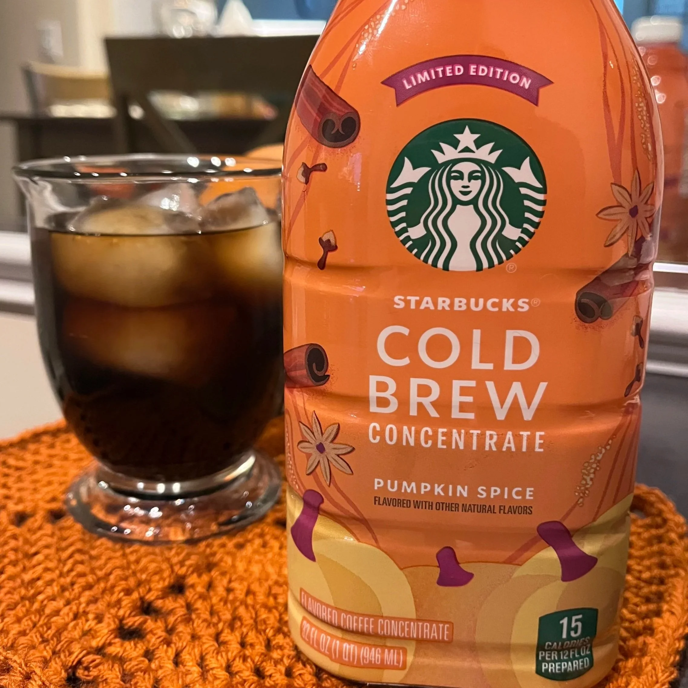 coffee mug next to jug of cold brew