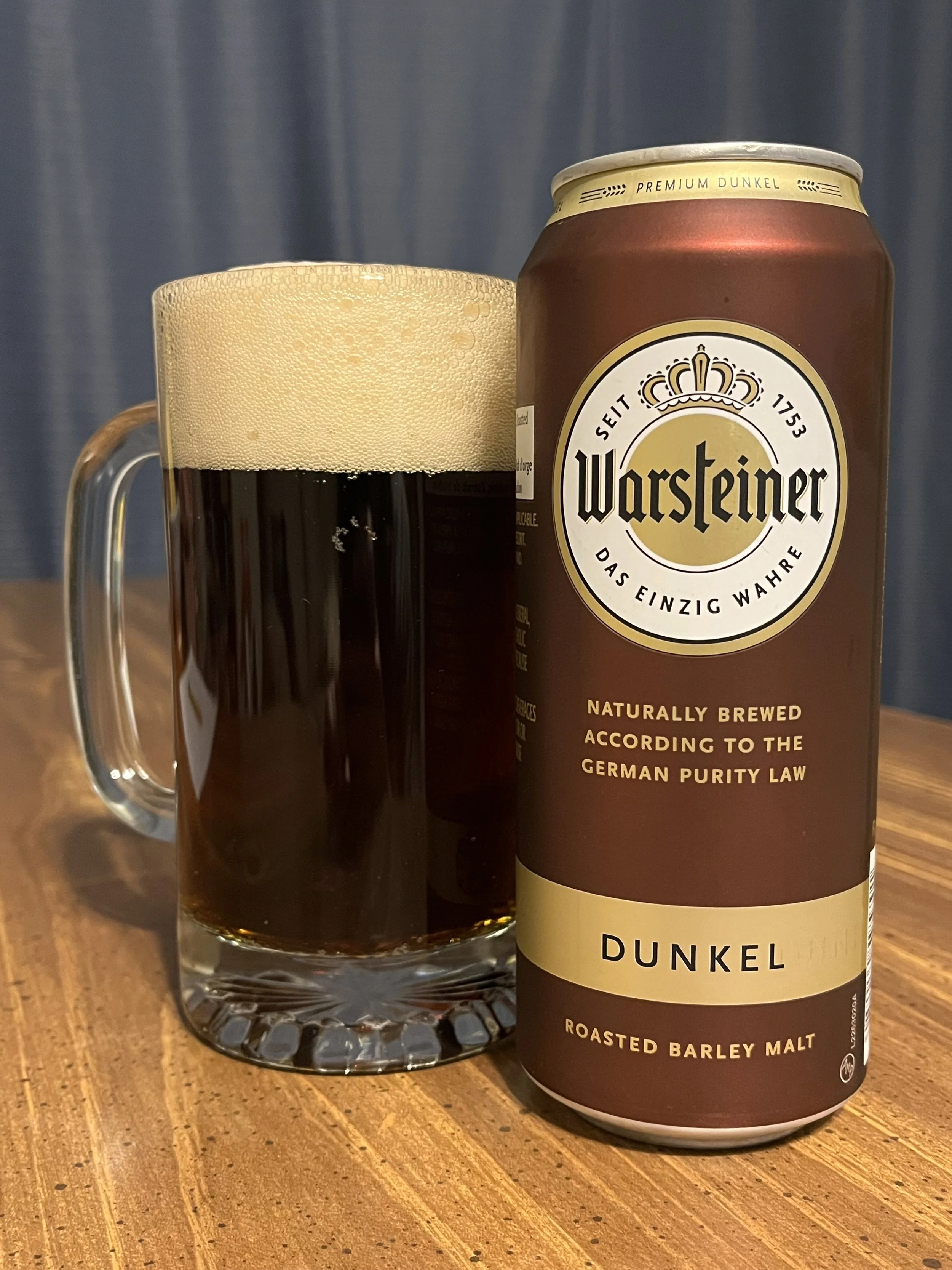 beer stein next to a Warsteiner beer can