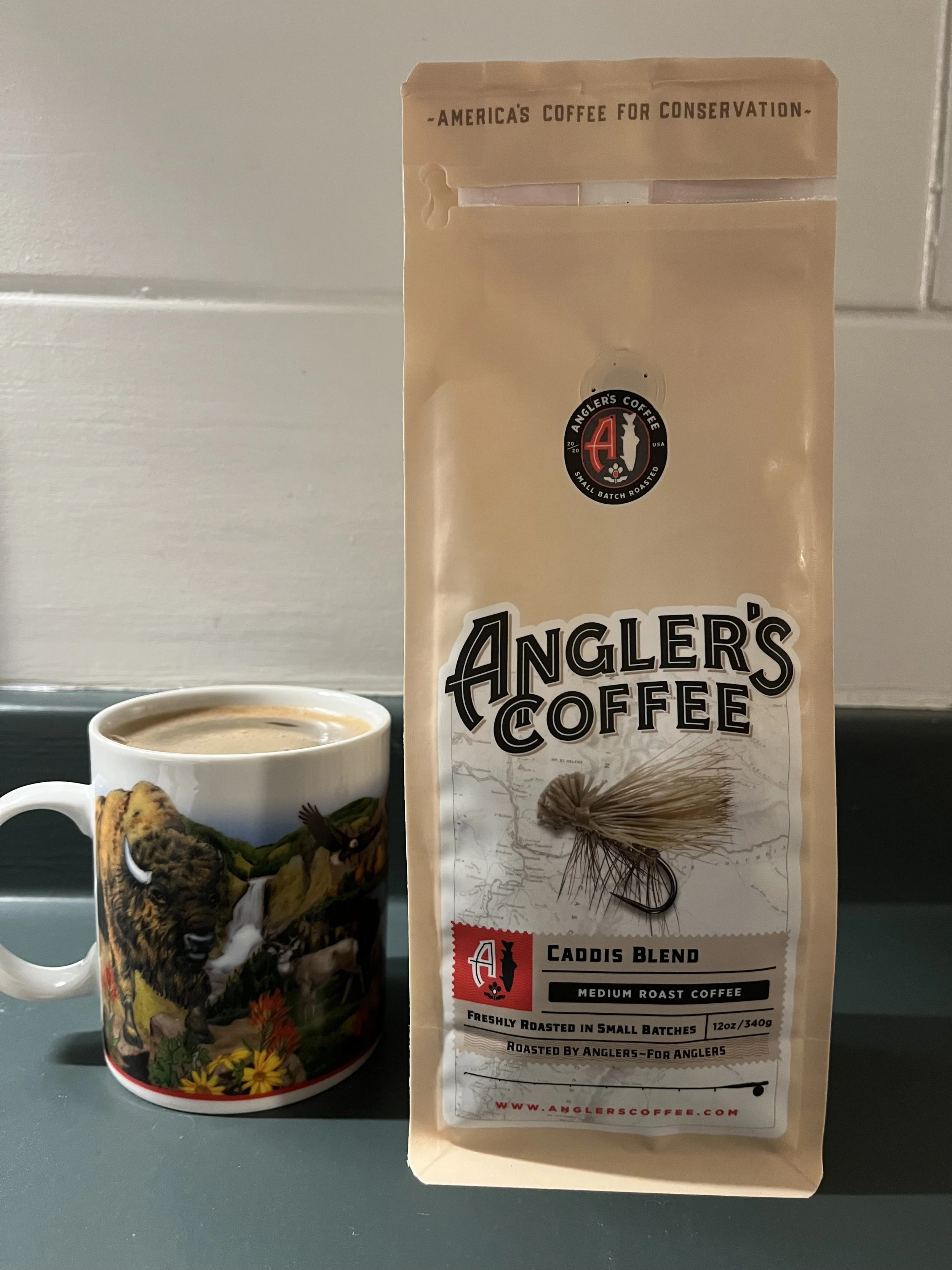 coffee mug next to bag of coffee beans