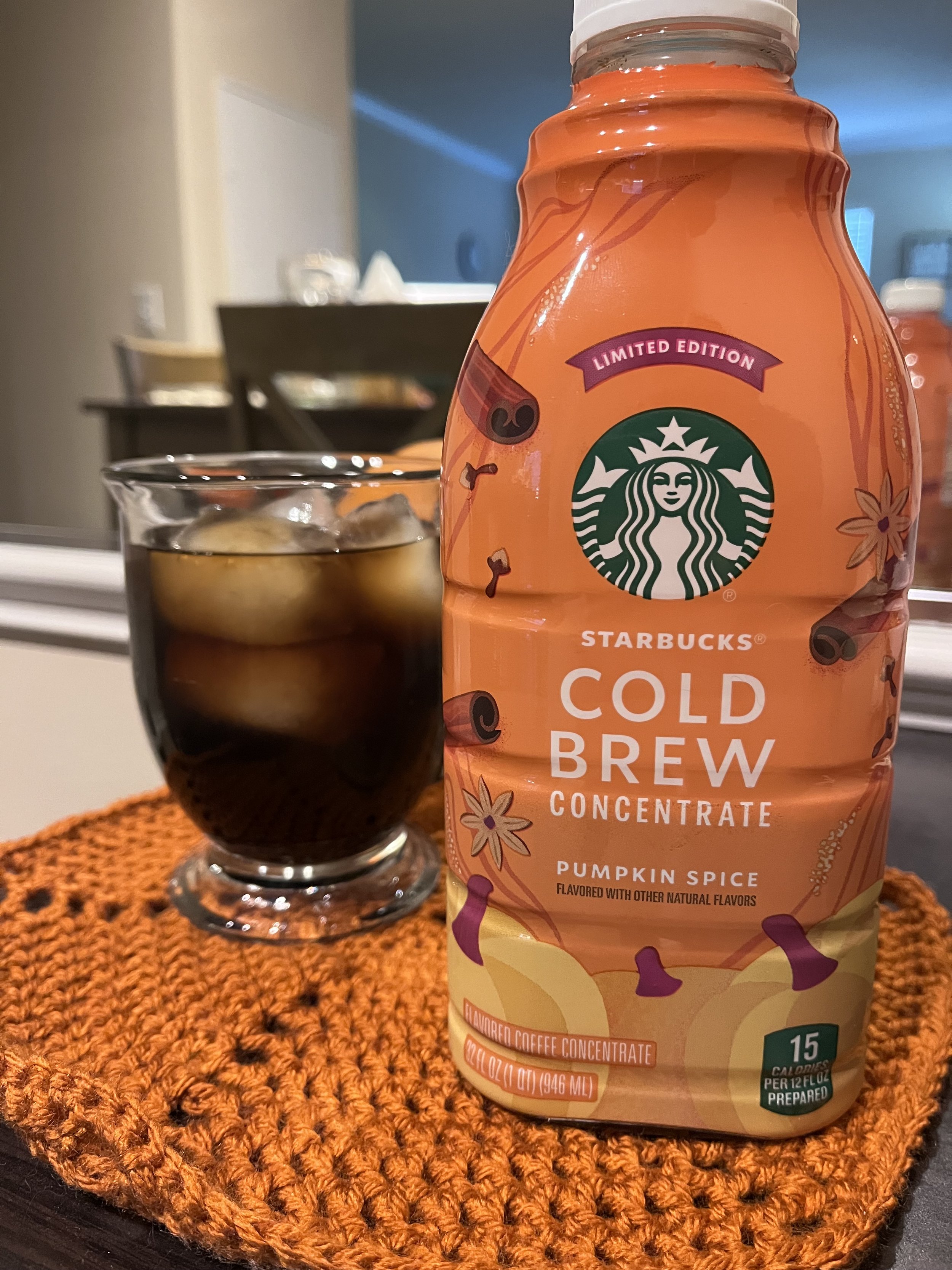 coffee mug of iced cold brew next to jug of starbucks cold brew
