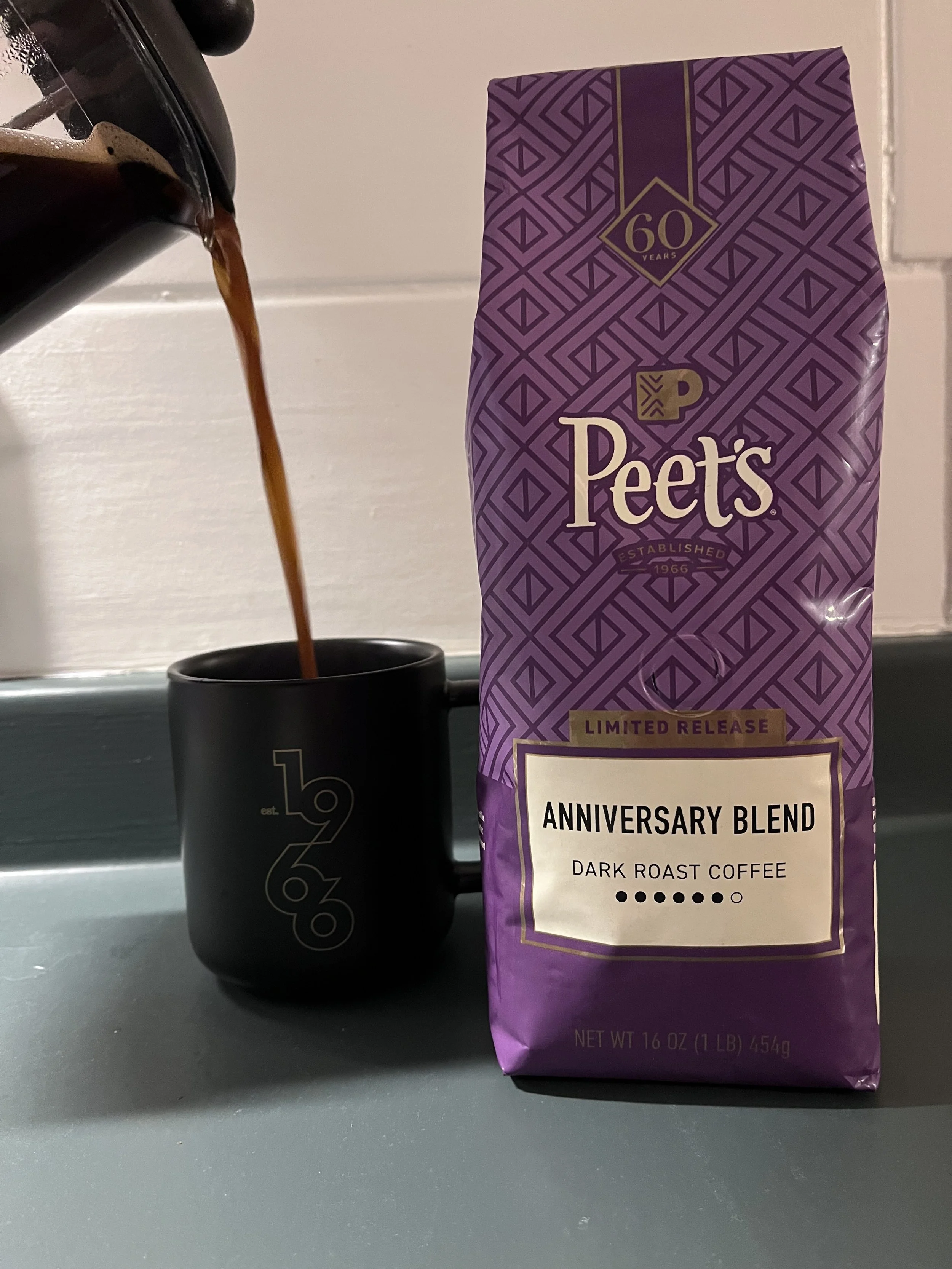coffee pouring into a mug, next to a bag of Peet's coffee beans