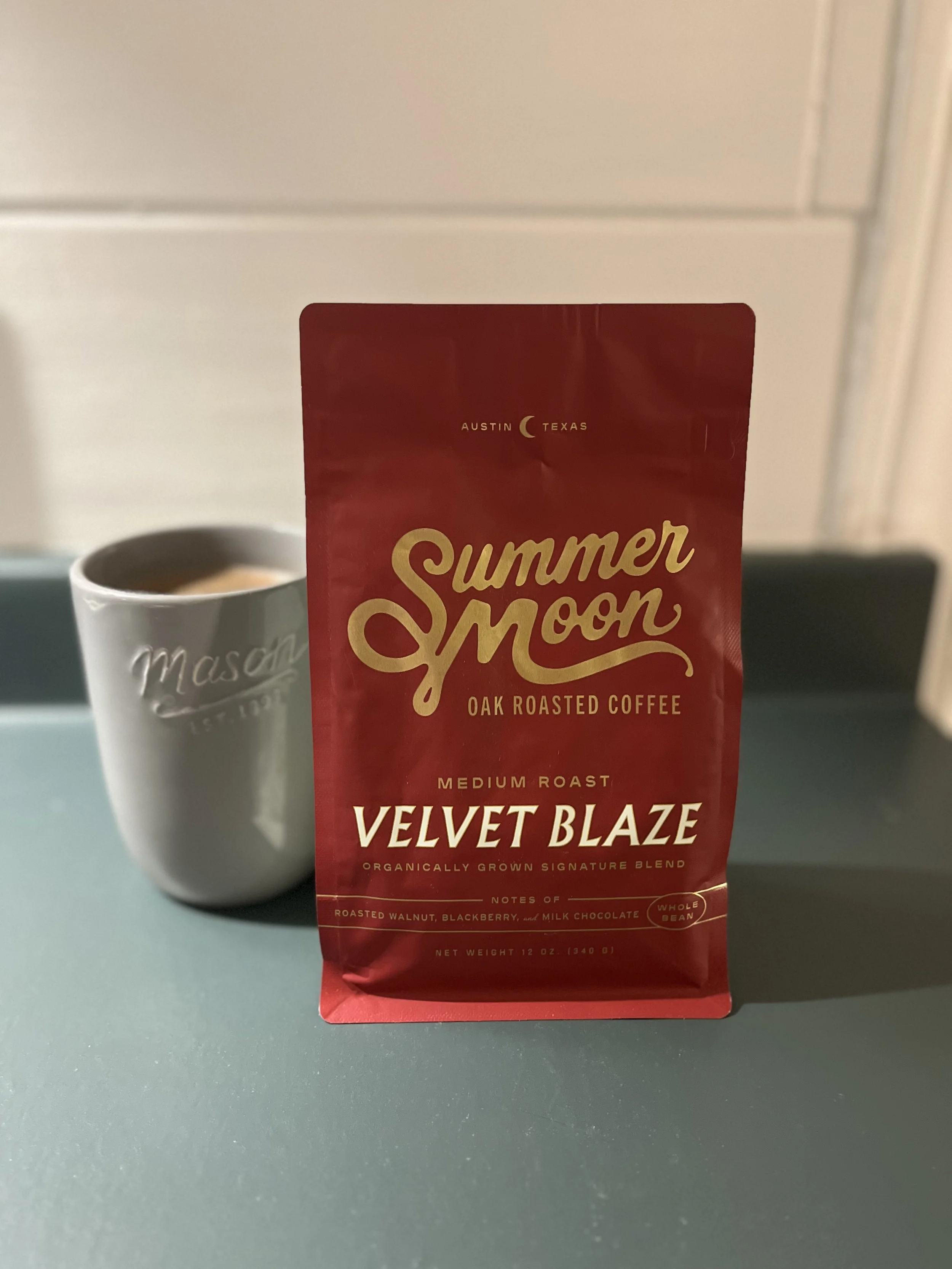coffee mug next to bag of Summer Moon beans