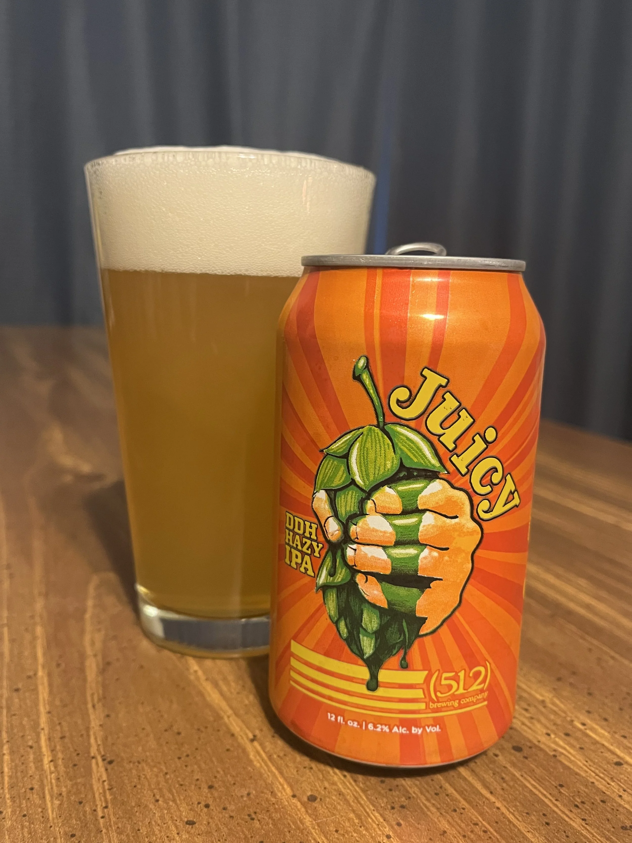 pub glass next to a (512) beer can
