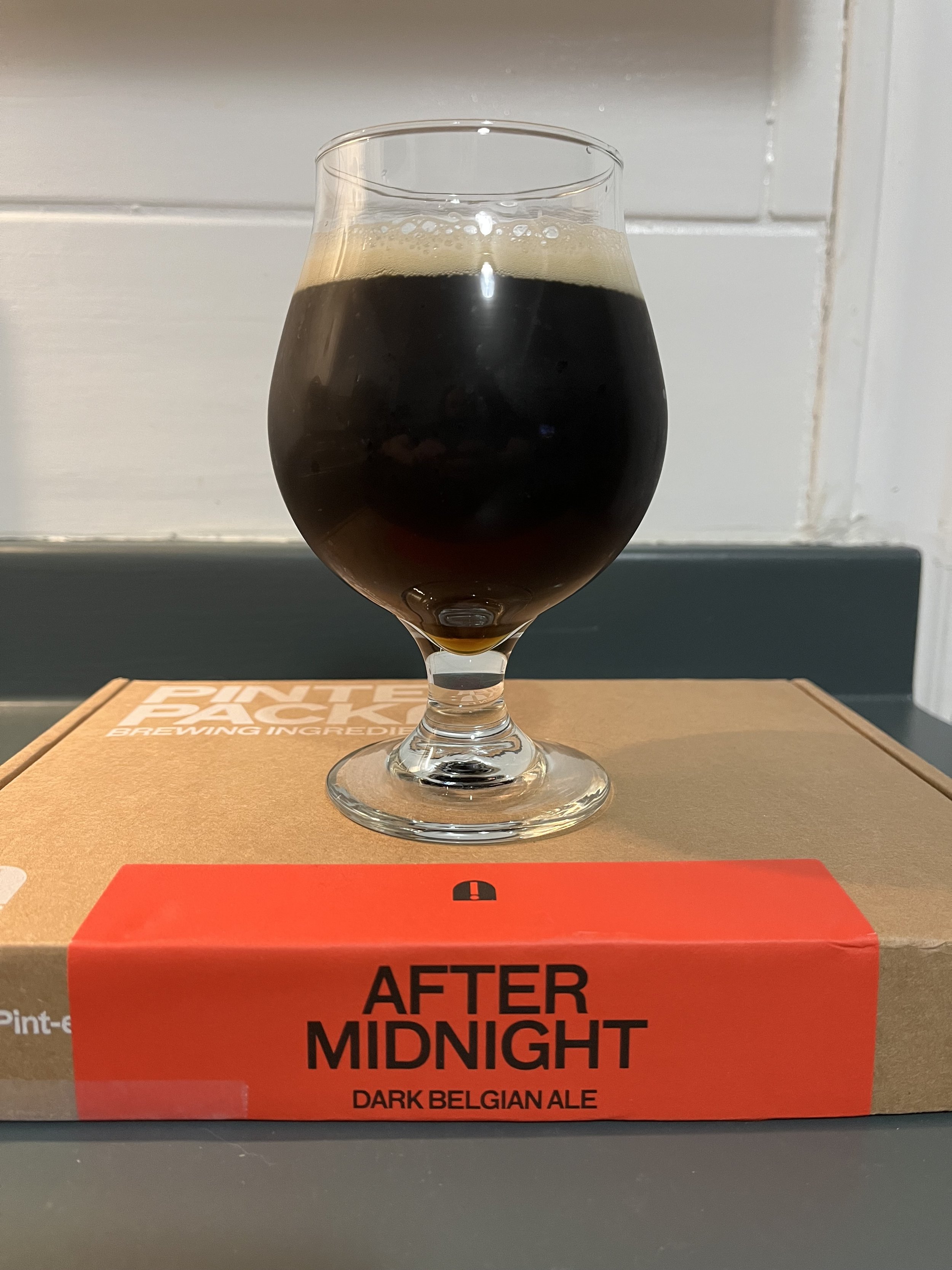 tulip glass on top of a Pinter After Midnight brew kit