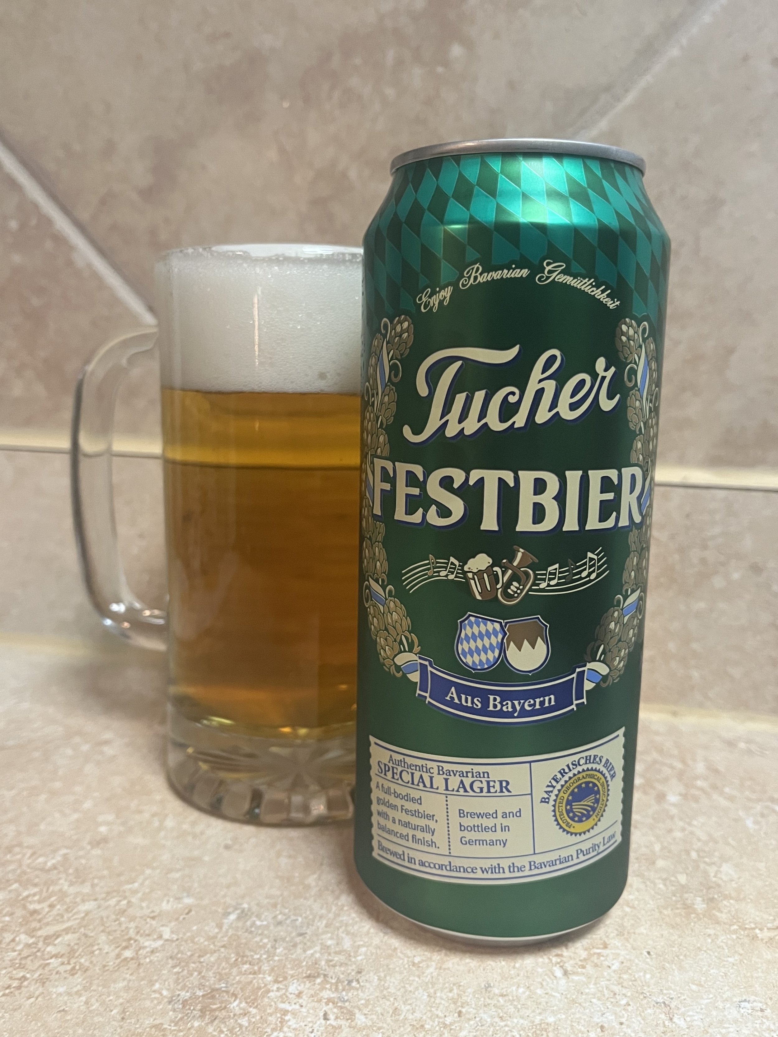 beer in a stein next to a beer can