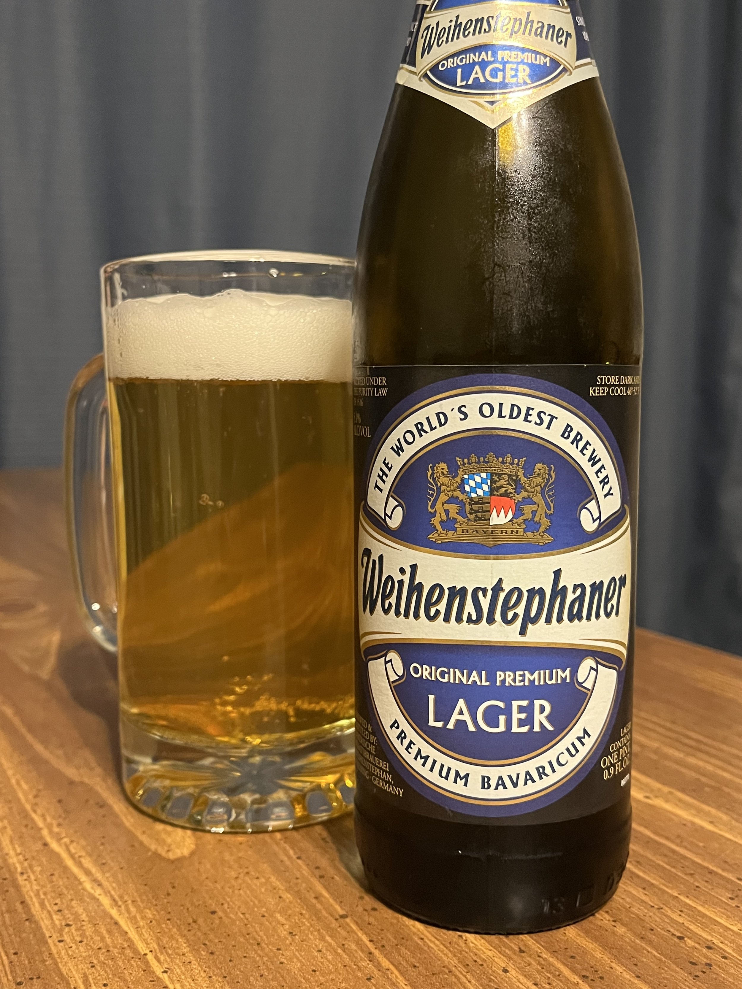 stein of beer next to beer bottle