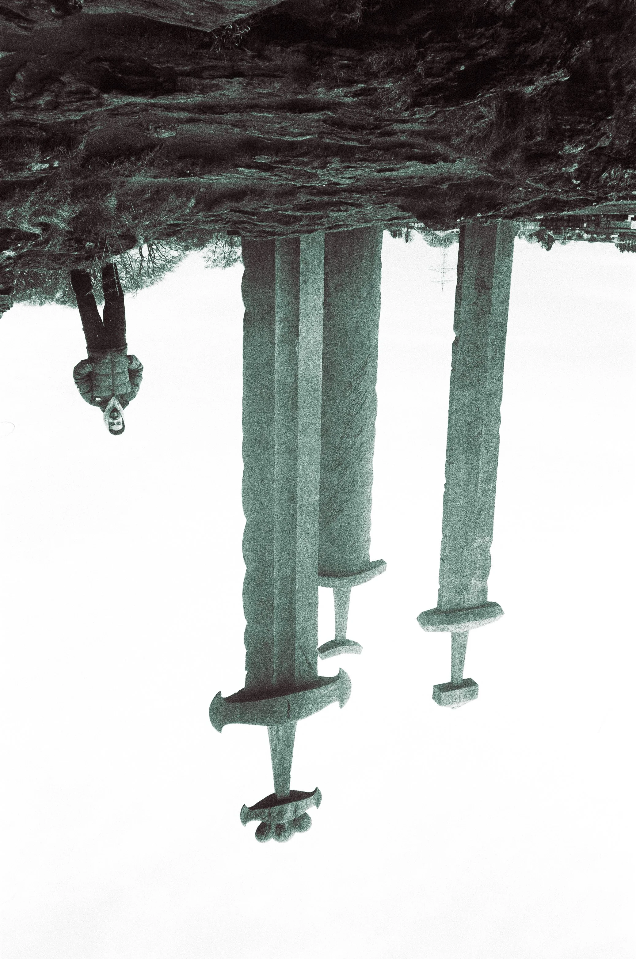 Black and white image of a vintage cuckoo clock with detailed wooden carvings and a pendulum.