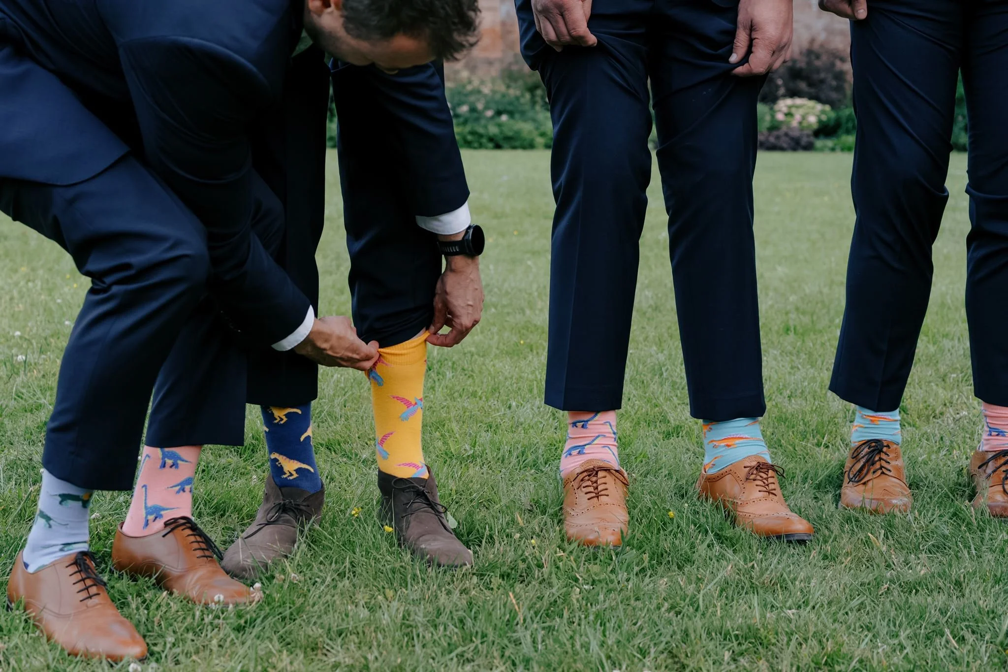 grooms wearing odd socks candid wedding photo