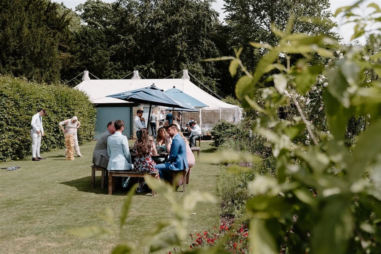 Guests relaxing in the garden during a small Stamford wedding reception at The William Cecil