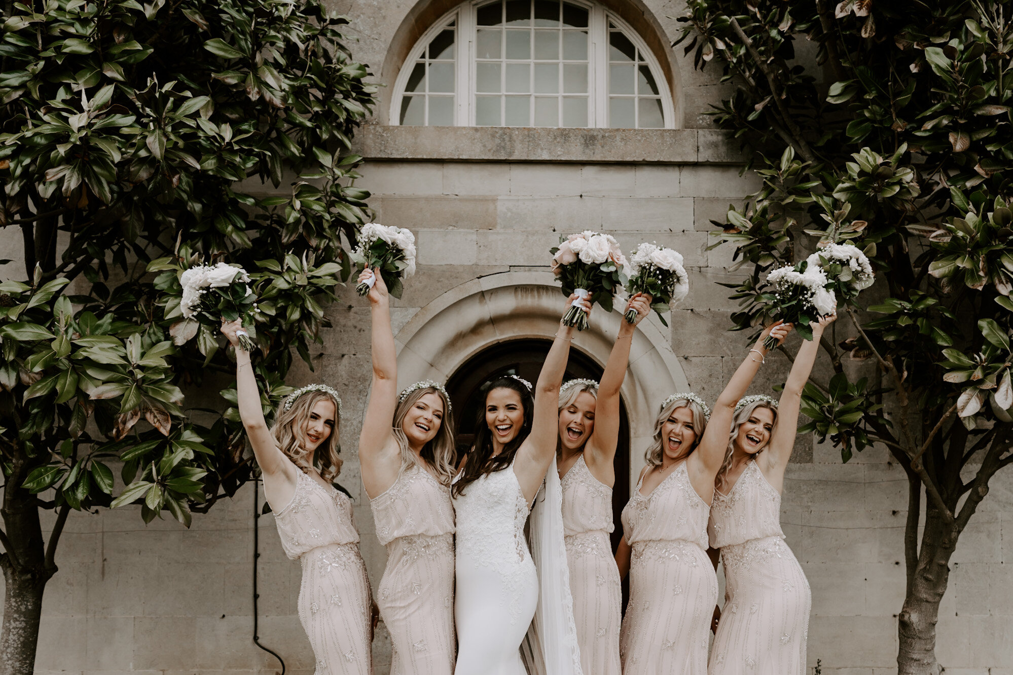 bridesmaids cheering with bride Stapleford Park Hotel Leicestershire wedding