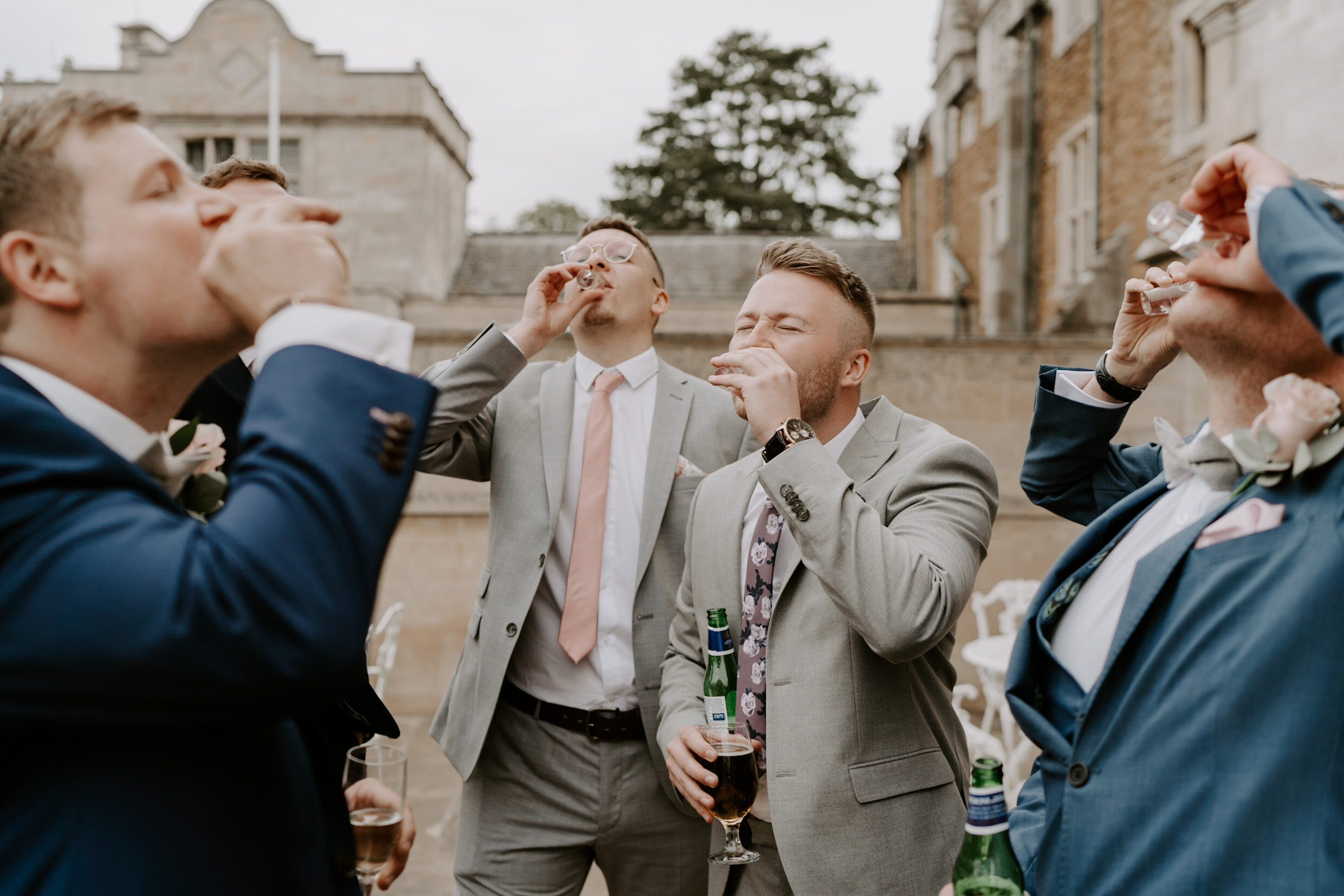 guests having shots Stapleford Park Leicestershire wedding