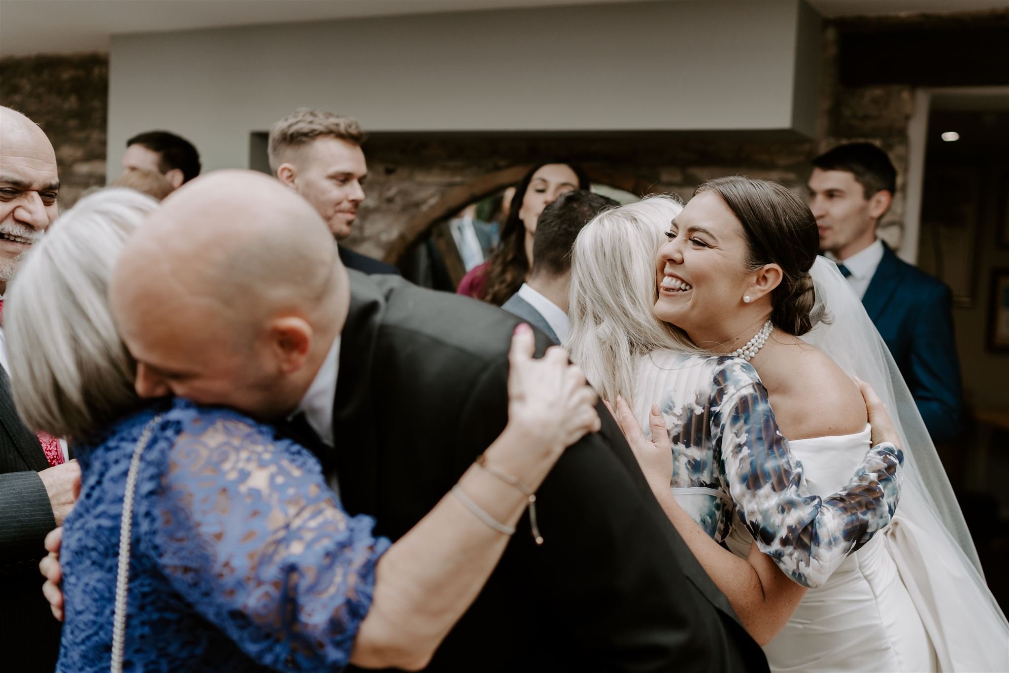 Bride hugging guests Documentary wedding photographs Barnsdale Lodge