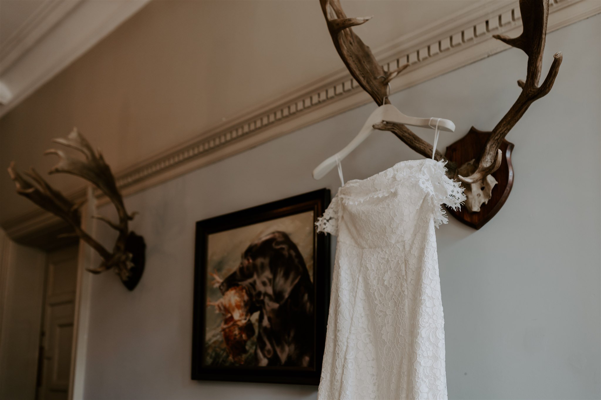 Wedding dress hanging in hallway William Cecil stamford 
