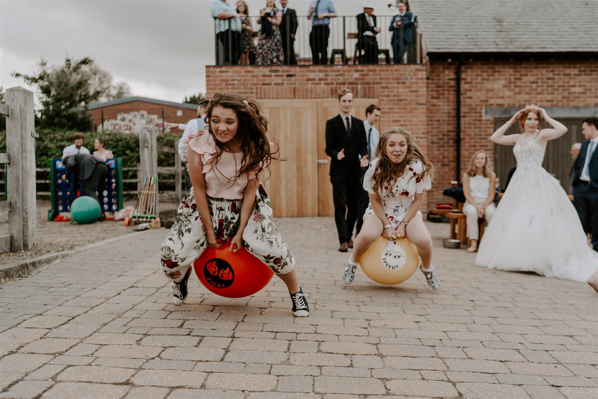 wedding guests space hopper jumping Stamford wedding photographer