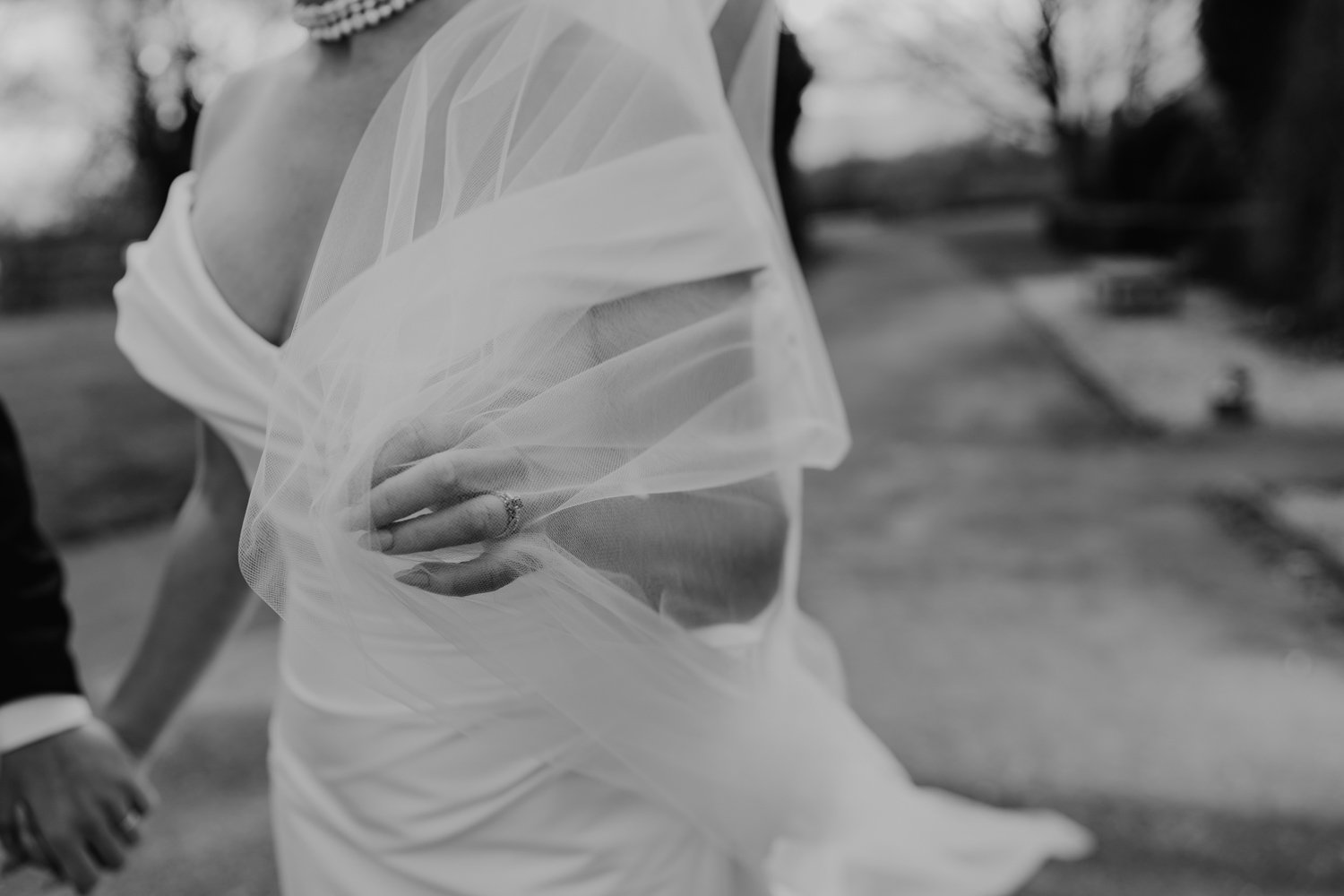 bride holding veil blowing wind Barnsdale Lodge hotel wedding photography