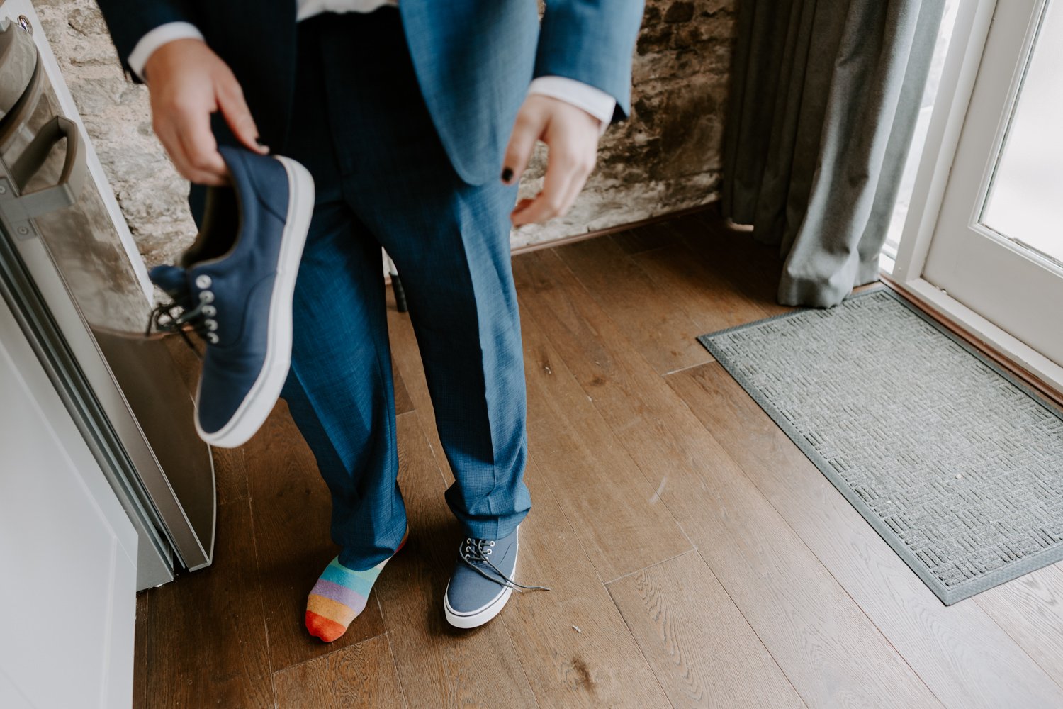 bestman with colourful rainbow socks mardi gras village hall wedding Peterborough