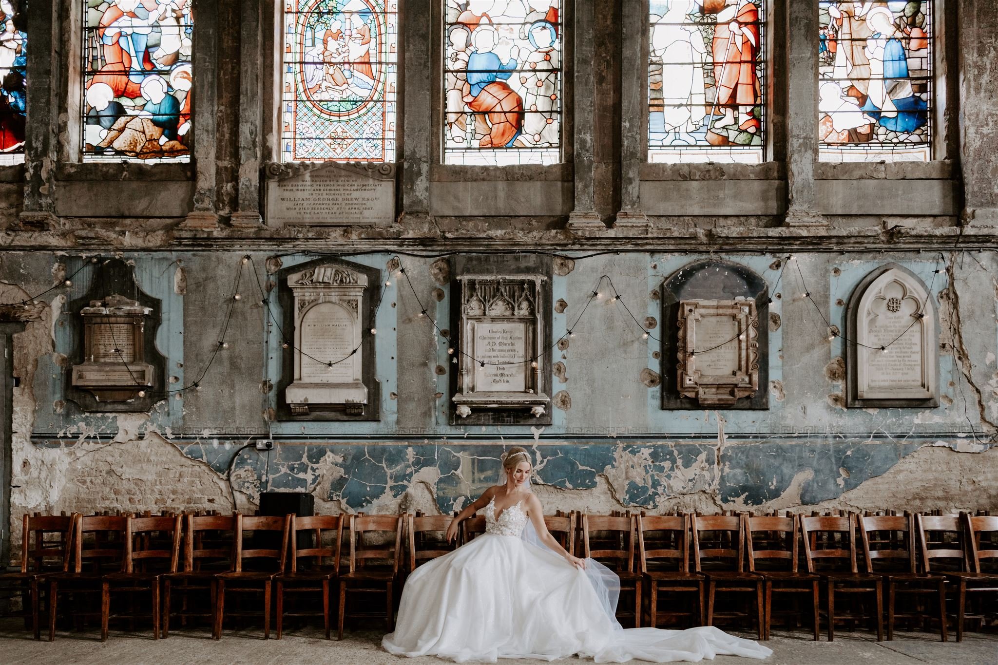 bride sitting by stained glass windows Asylum Chapel Top London Wedding venue