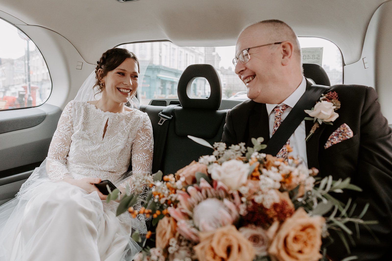 bride in taxi with father London wedding photography