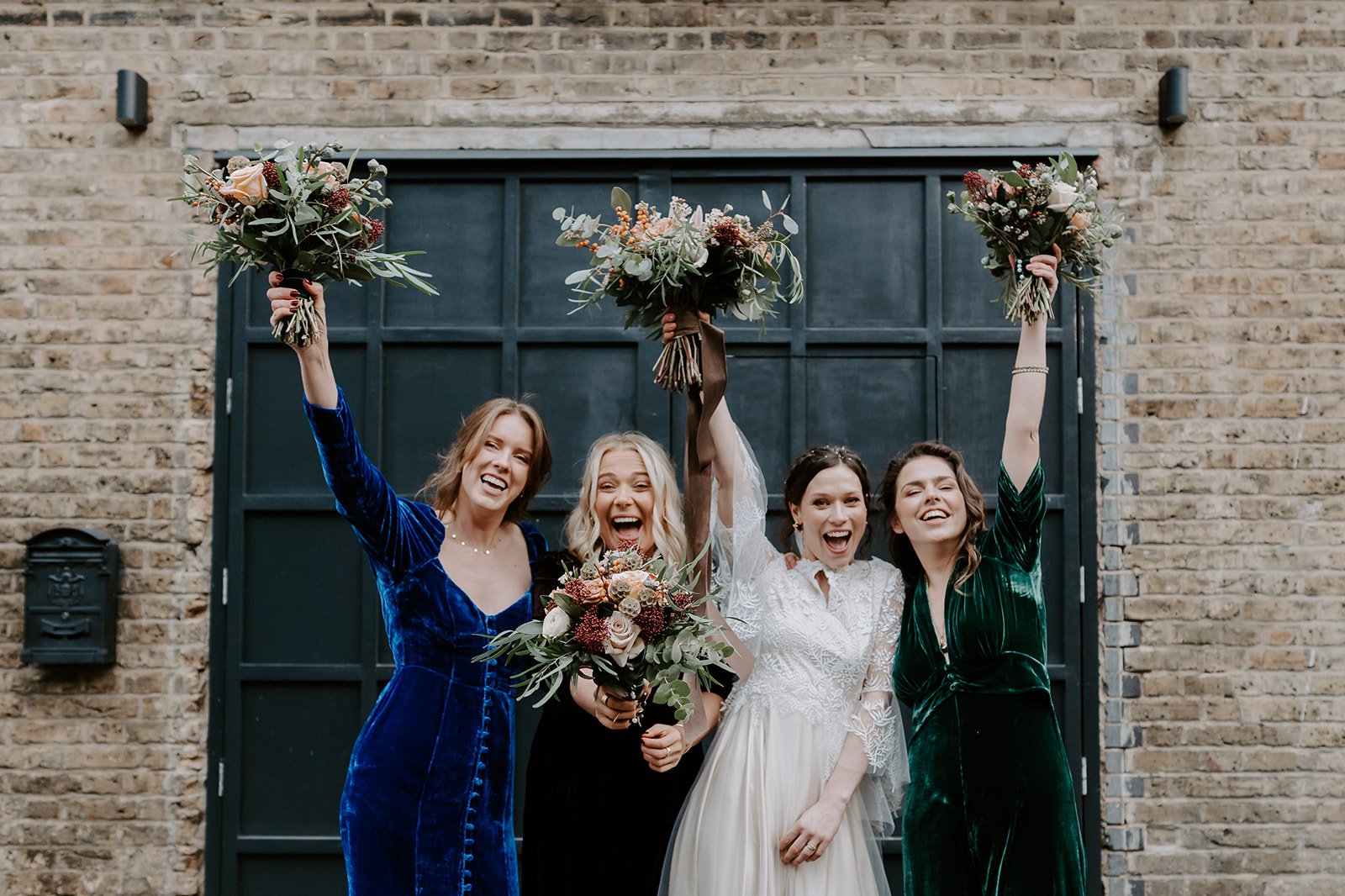 bridesmaids cheering with bouquets in air London wedding photography