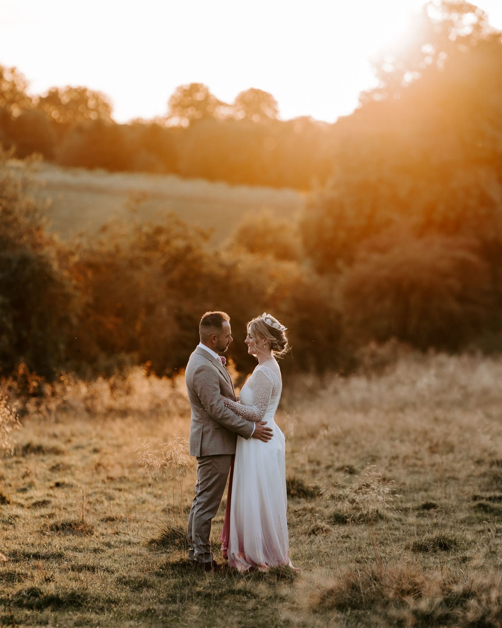 couple hugging during golden hour at Buckminister Barns wedding venue 