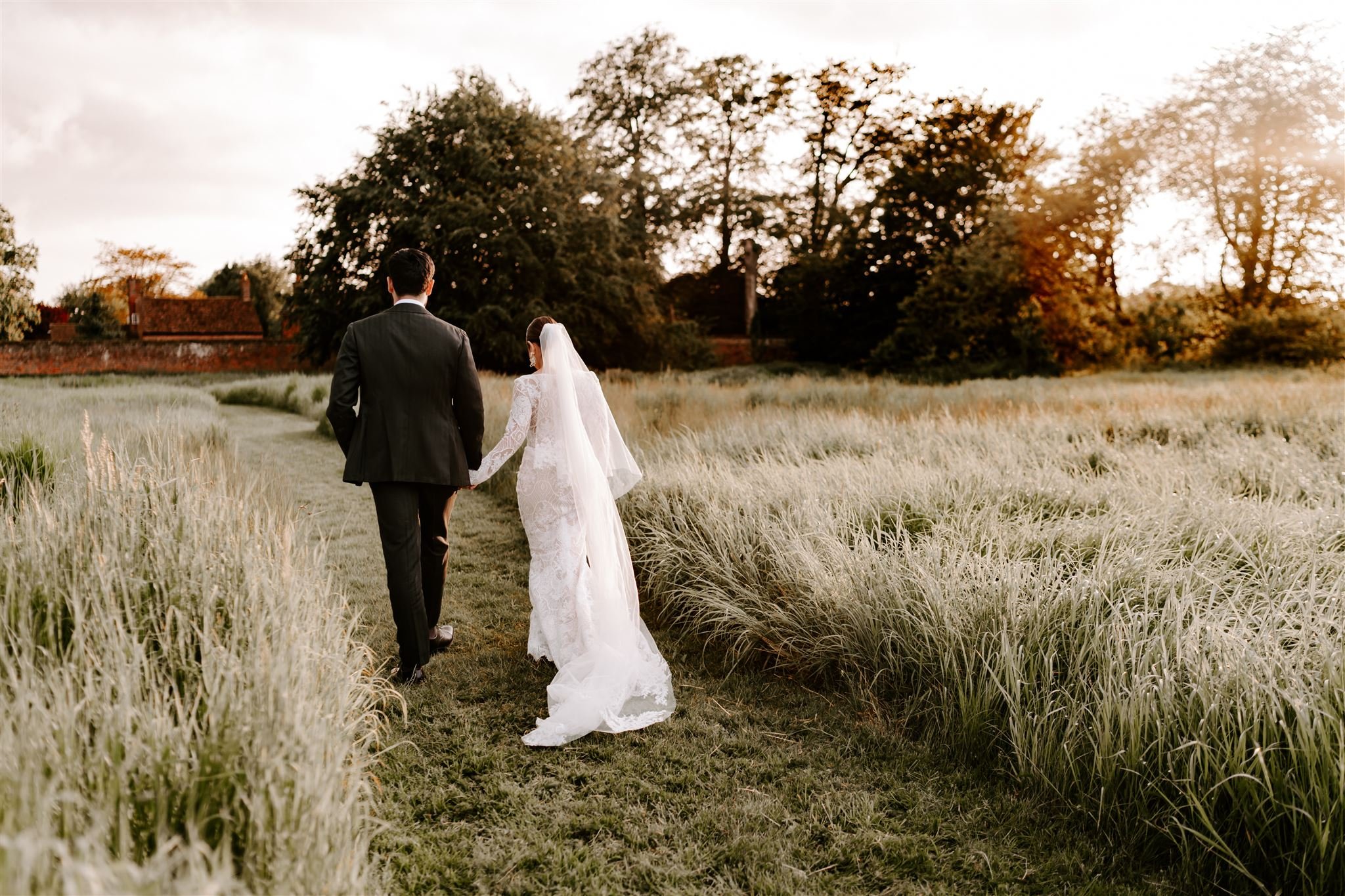 bride groom walking holding hands into sunset during golden hour Offley place wedding 