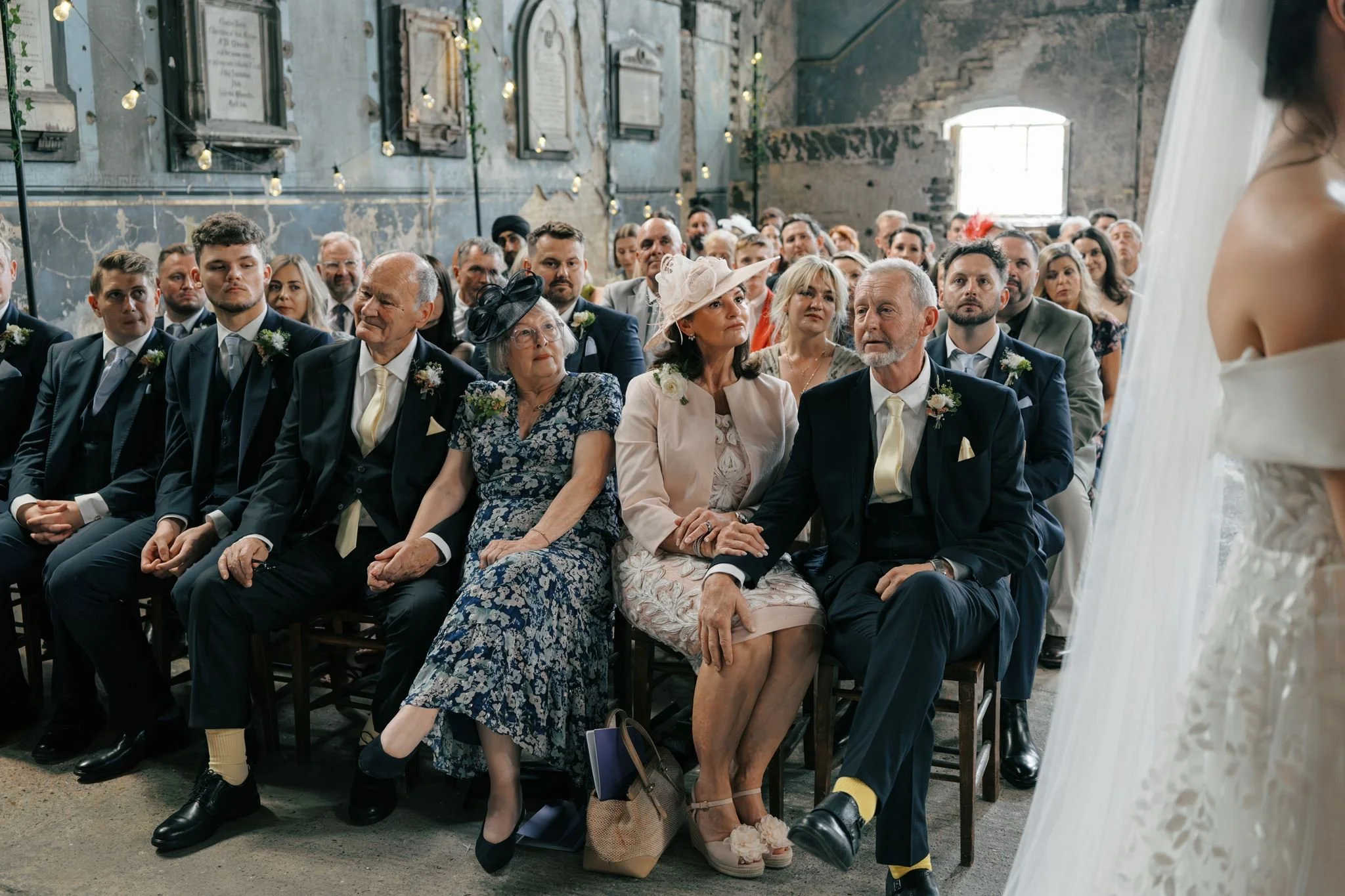 wedding guests watching emotional ceremony at Asylum Chapel London | Gina Fernandes Photography