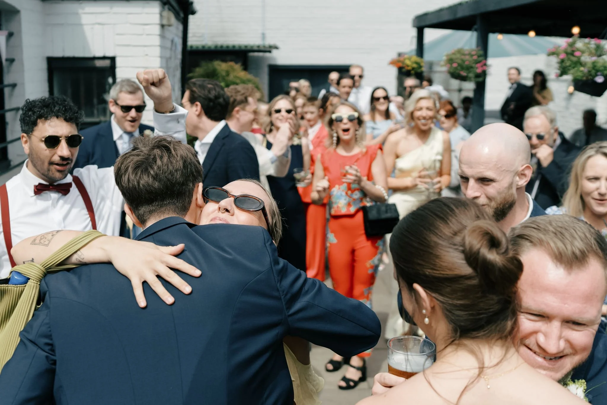 wedding guests hugging bride and groom  | Gina Fernandes Photography