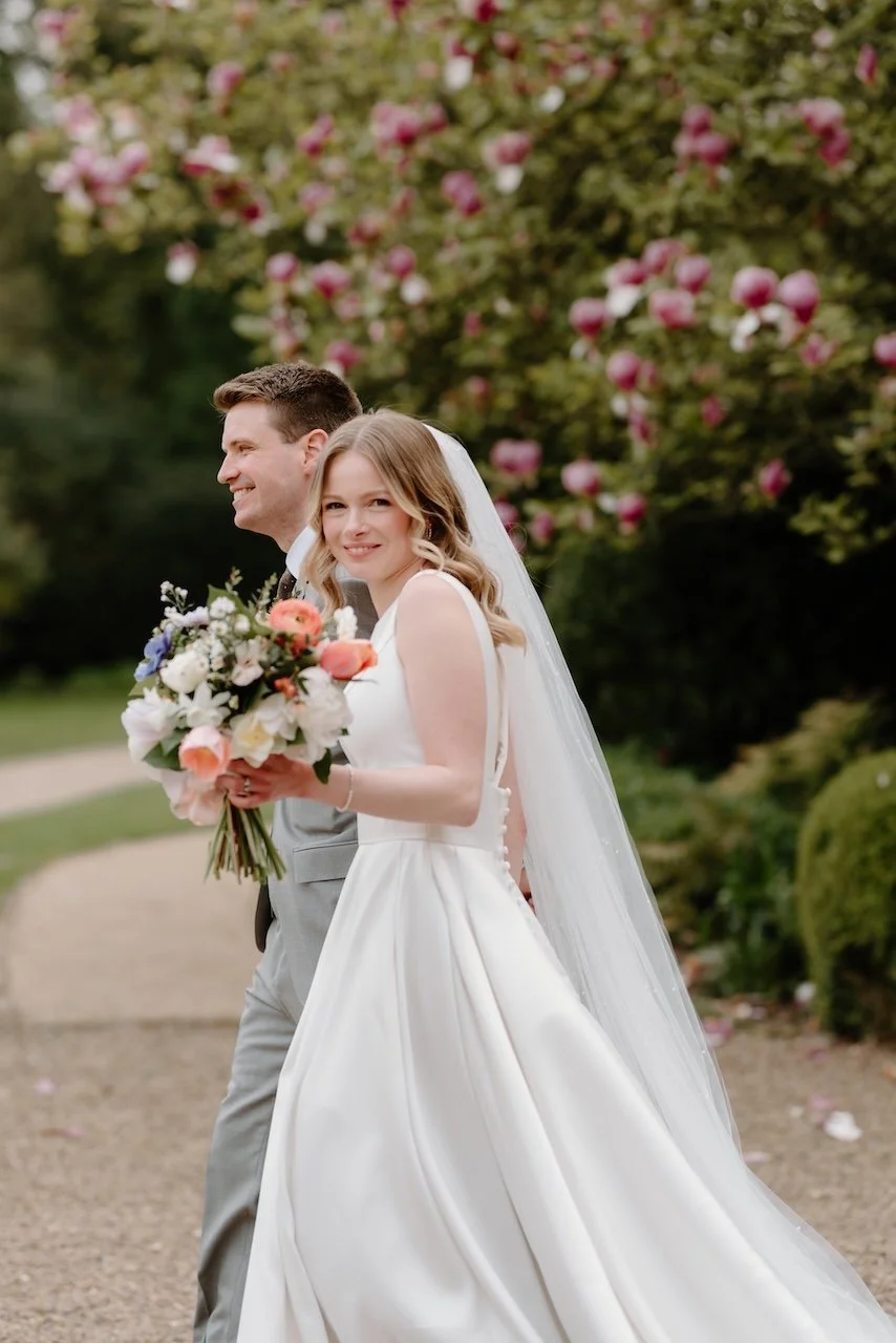 Bride and groom walking through the gardens at Dunston Hall Estate in Derbyshire