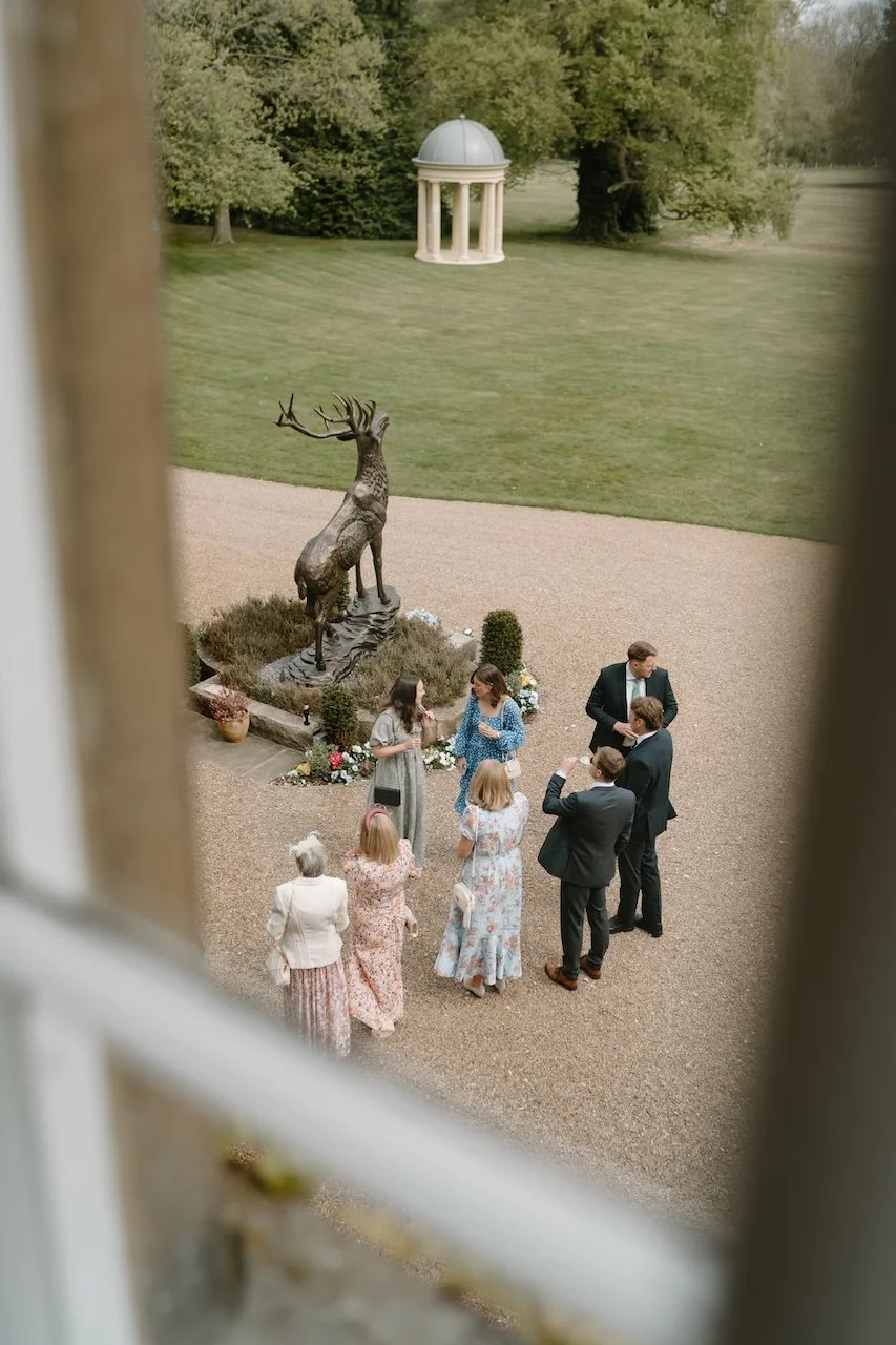 Wedding guests mingling in the courtyard at Dunston Hall Estate in Derbyshire