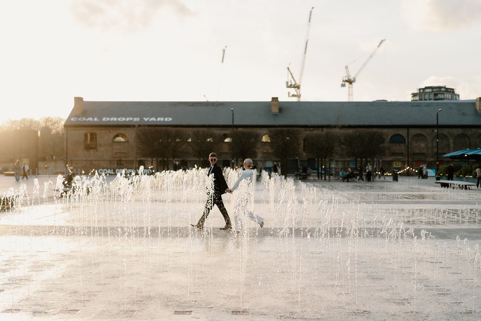 bride groom walking through water fountains small london wedding
