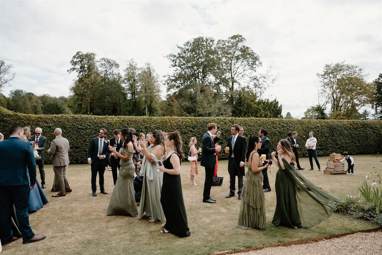 Guests chatting and celebrating during a Stamford wedding drinks reception, documentary led photography