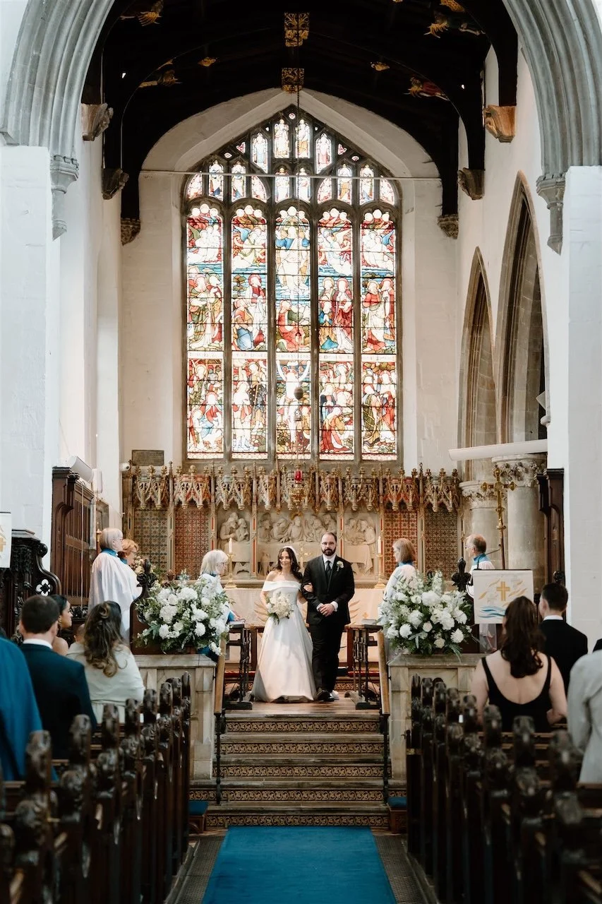 Bride and groom standing at the altar during a Stamford church wedding, documentary wedding photography