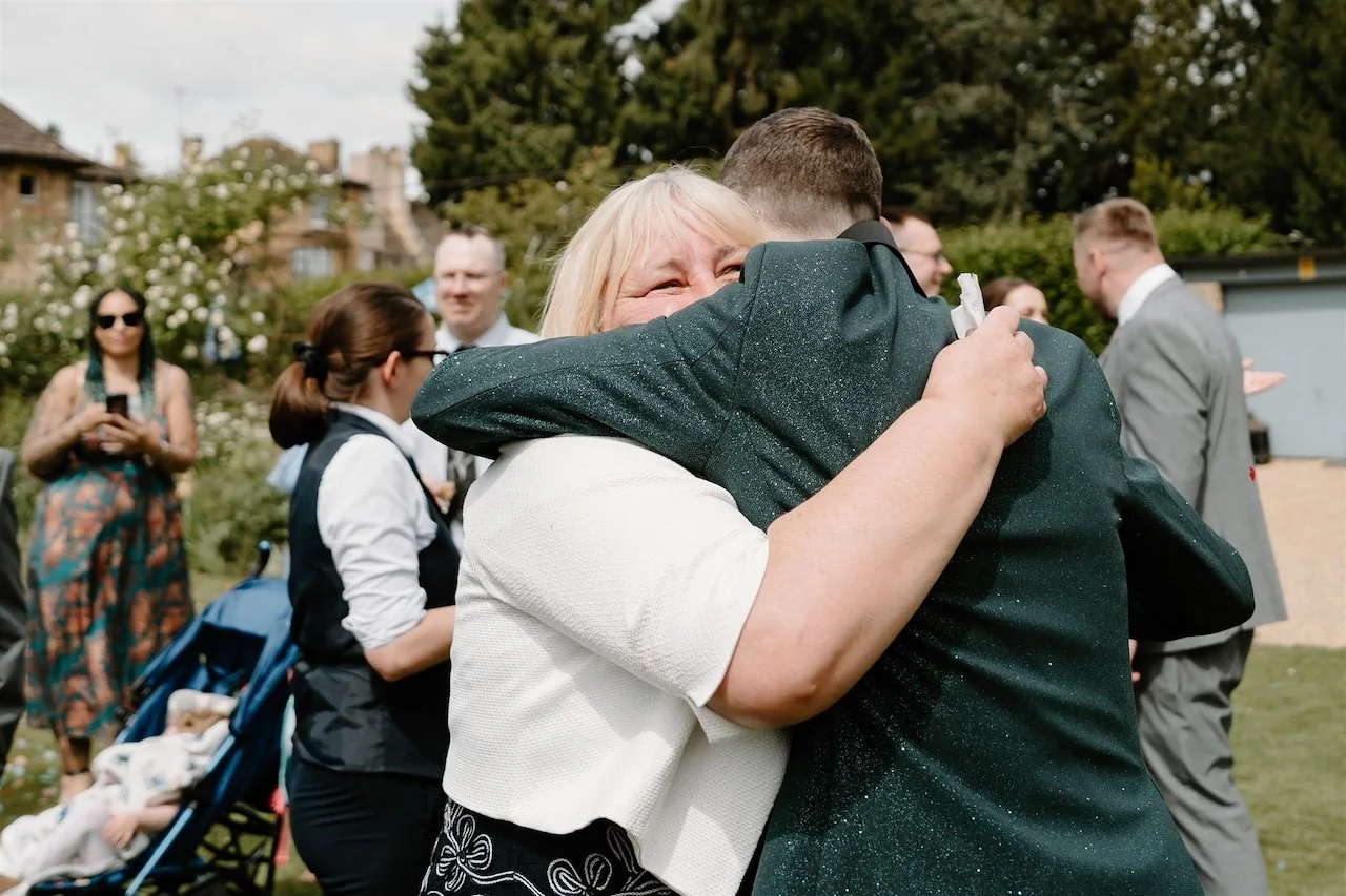 Emotional hug between groom and family member during an intimate Stamford wedding at The William Cecil