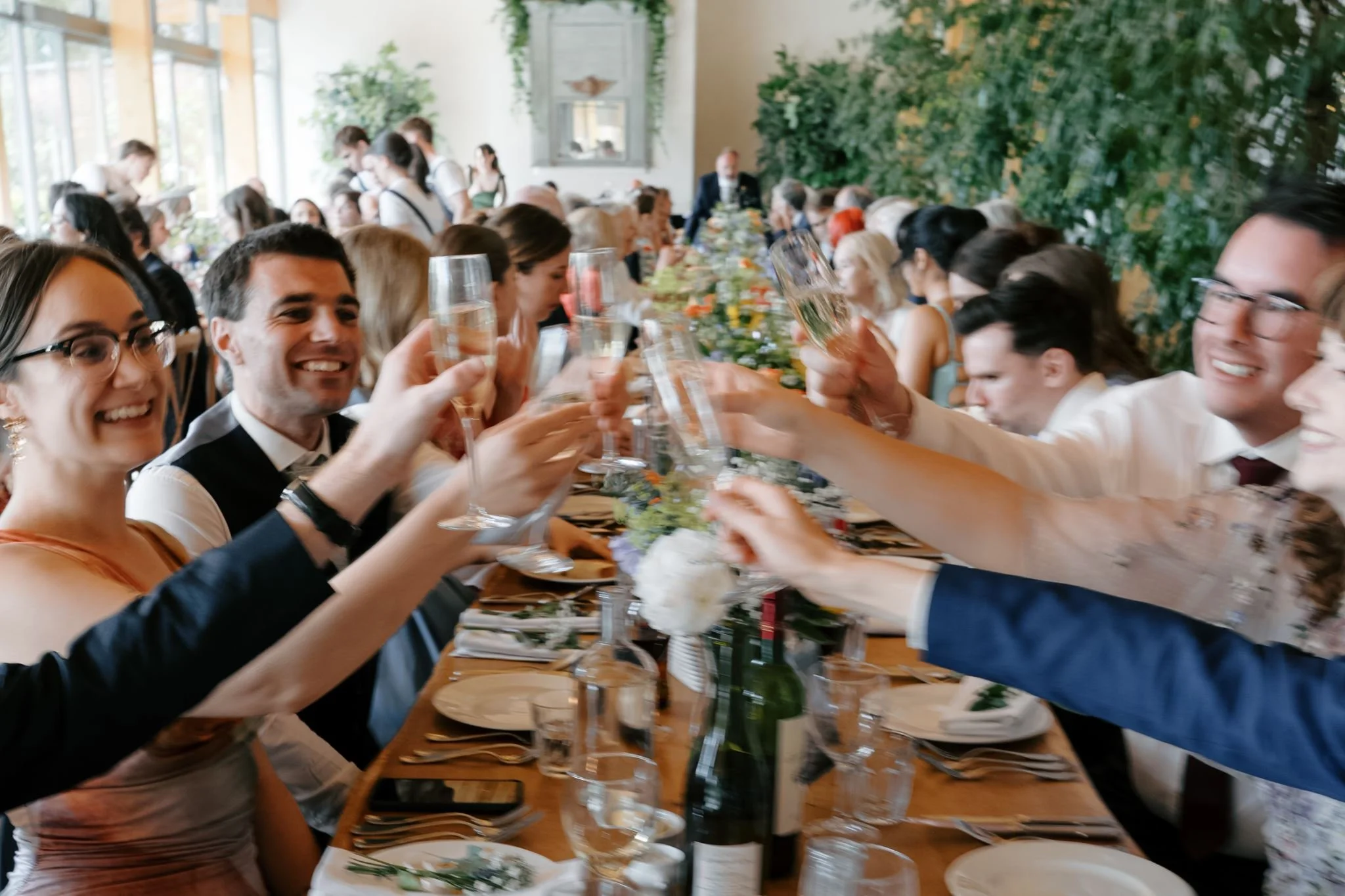 wedding guests toasting with champagne candid wedding photo