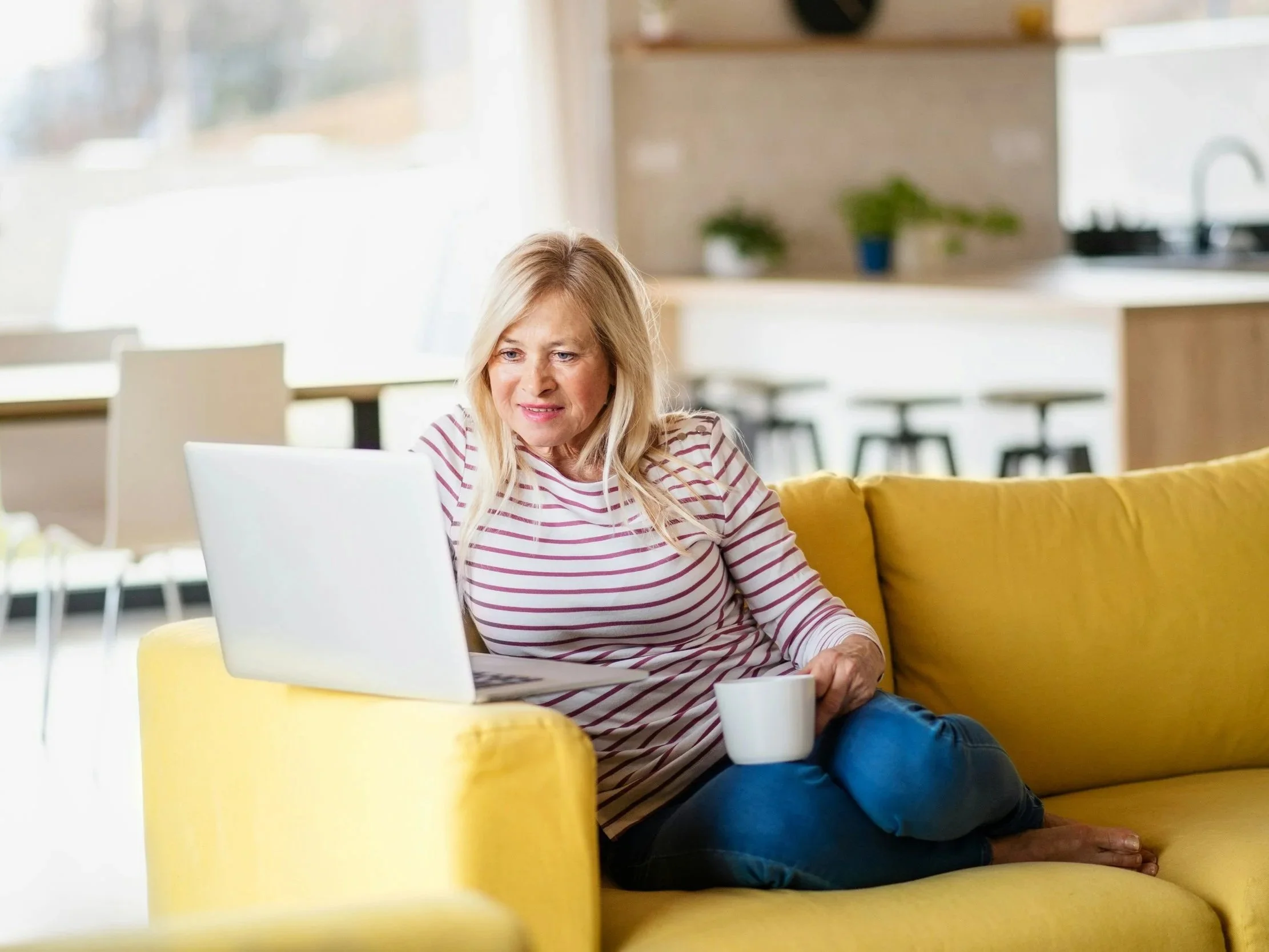 Woman sitting at home using a laptop.