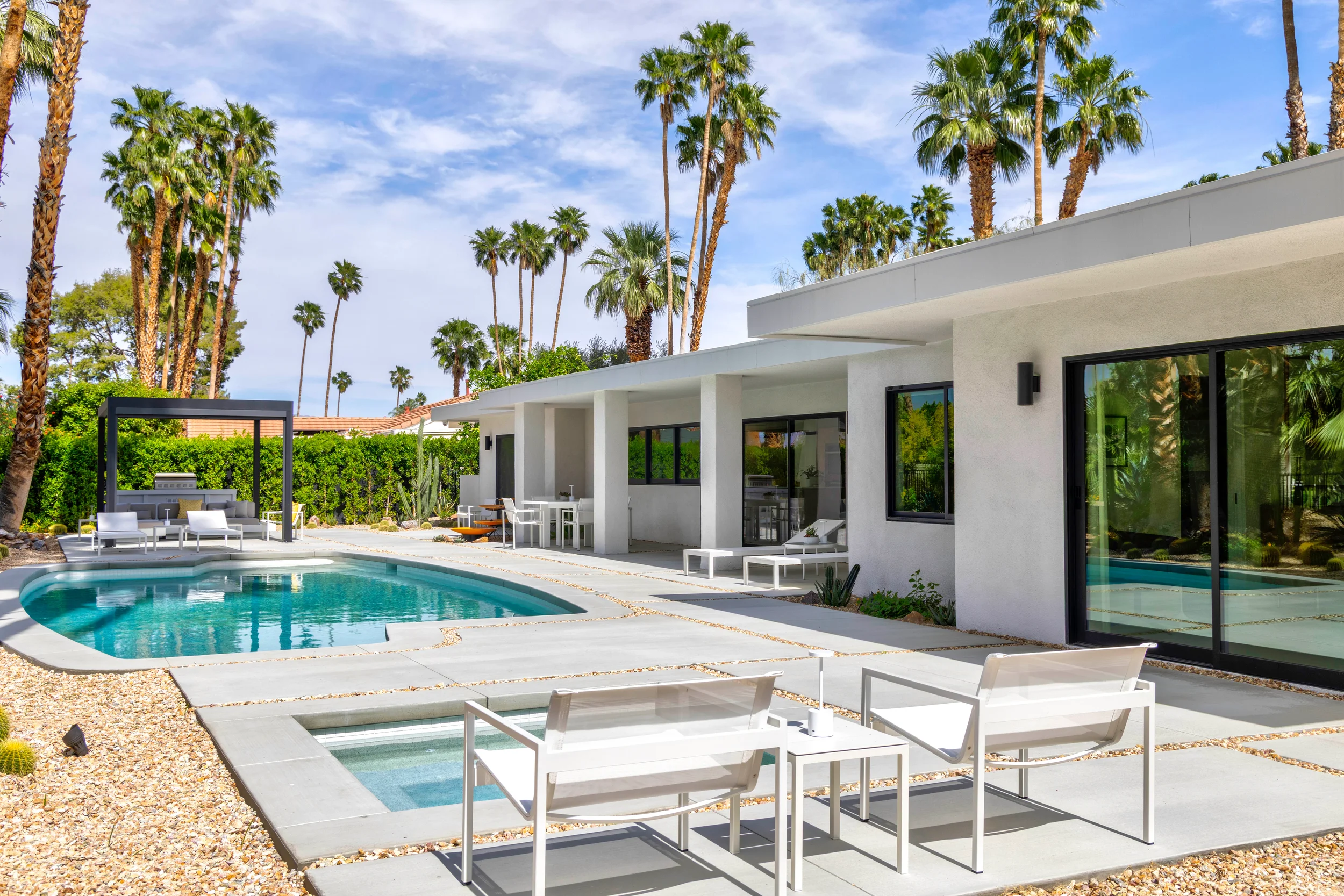 Palm Springs modern desert backyard with mountain views, agave, cacti, and gravel landscape creating a layered outdoor space.