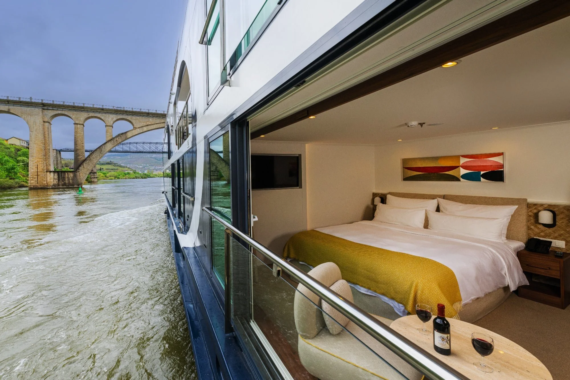 Avalon Waterways open-air balcony cabin with floor-to-ceiling windows overlooking river