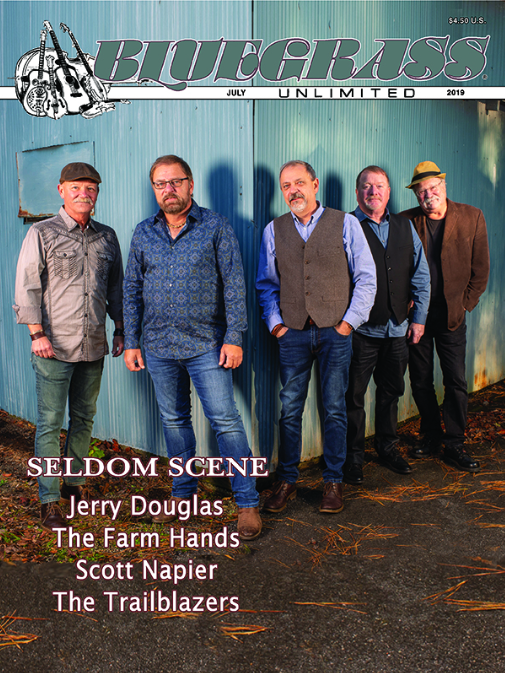 Cover of Bluegrass Unlimited magazine featuring five men standing outdoors against a blue corrugated metal background, with magazine title and article headlines.