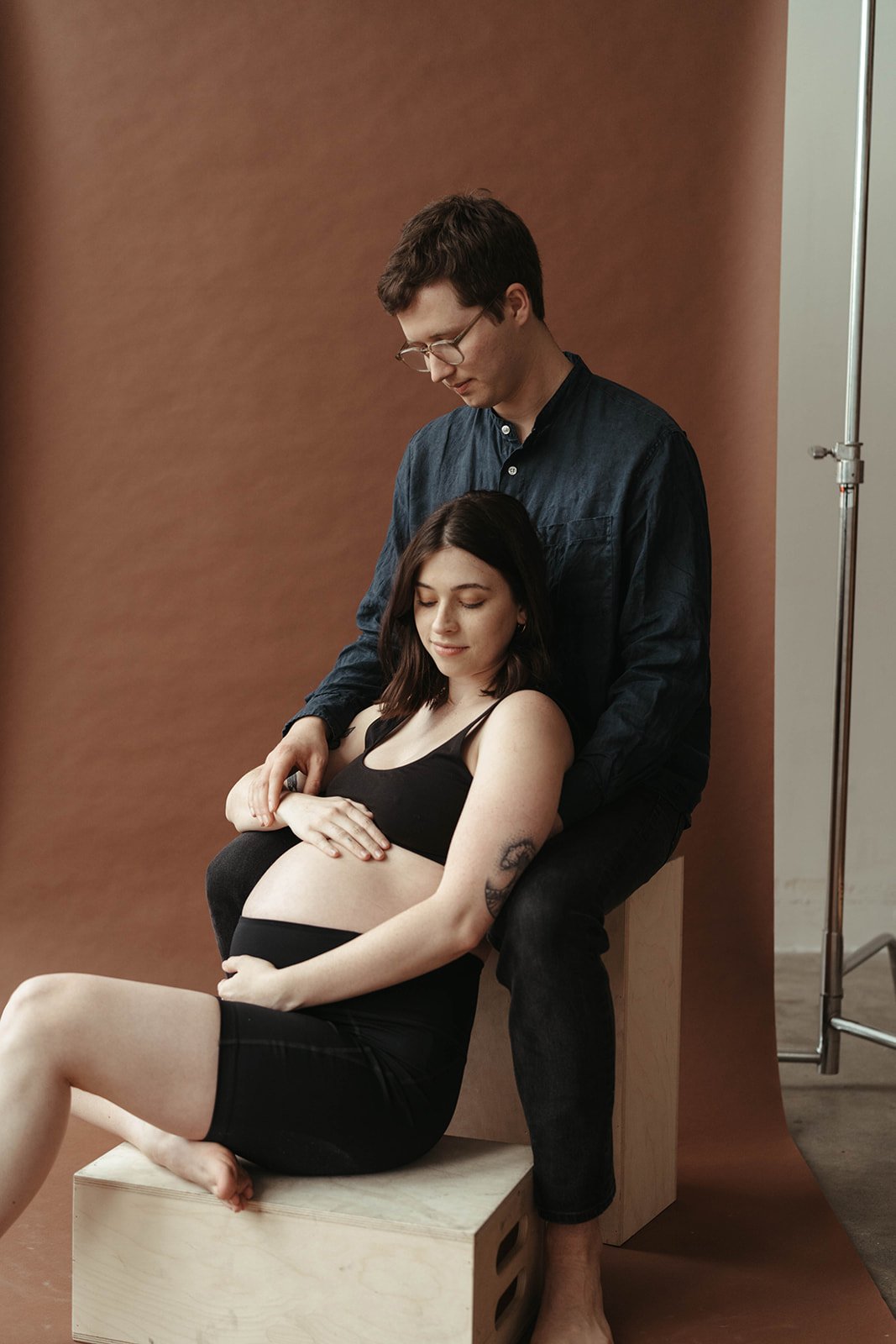 couple maternity session modern color backdrop
