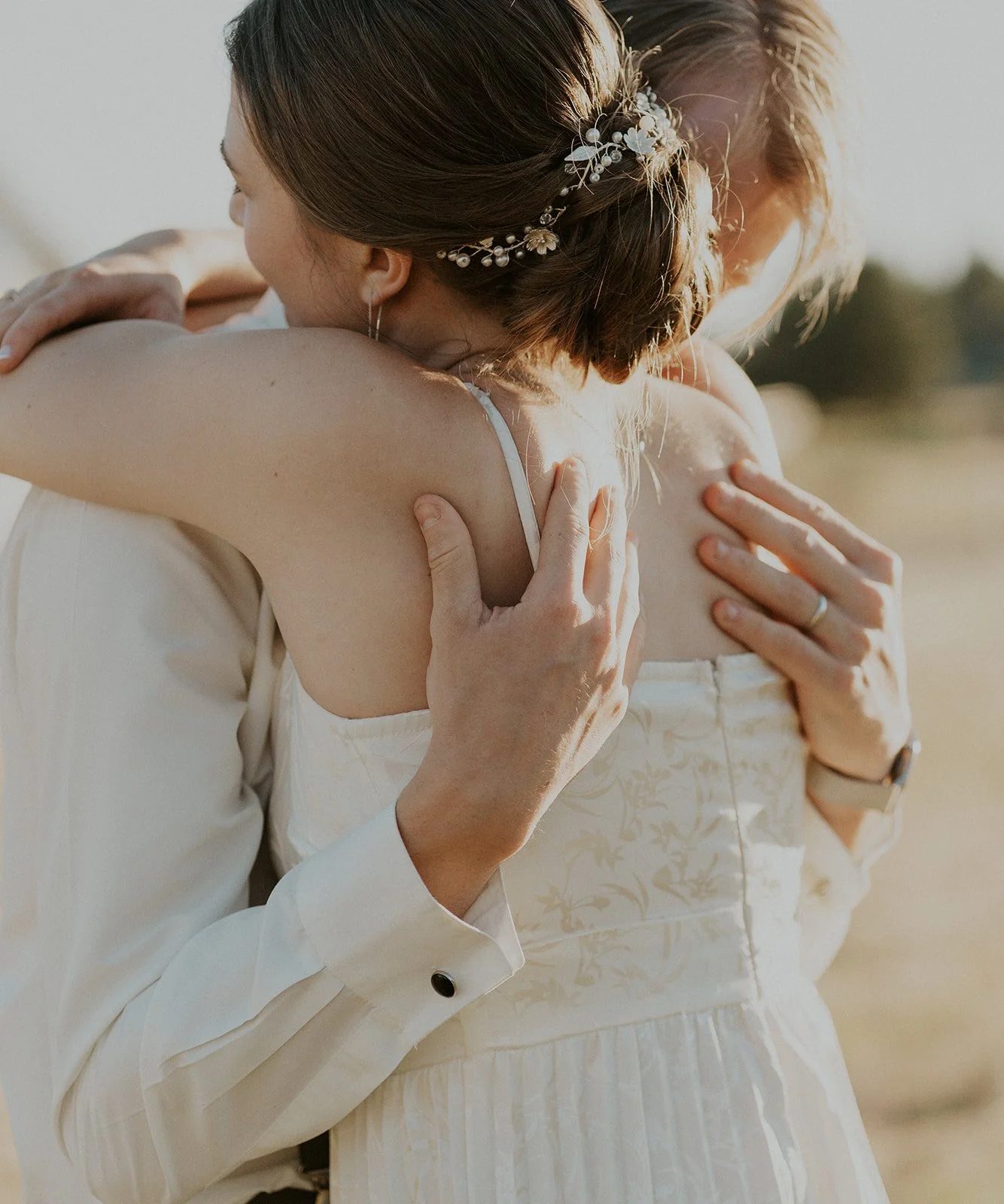 bride and groom embracing at sunset