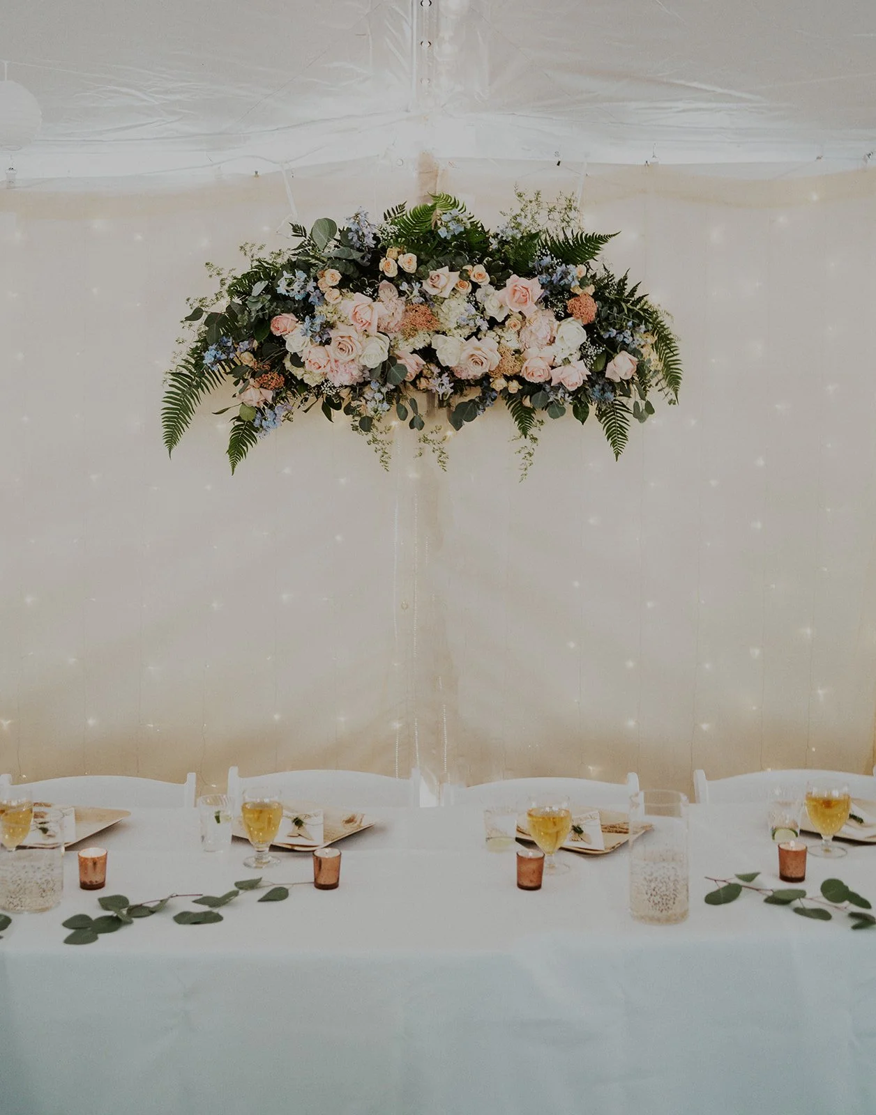 beautiful floral arrangement hanging above reception table